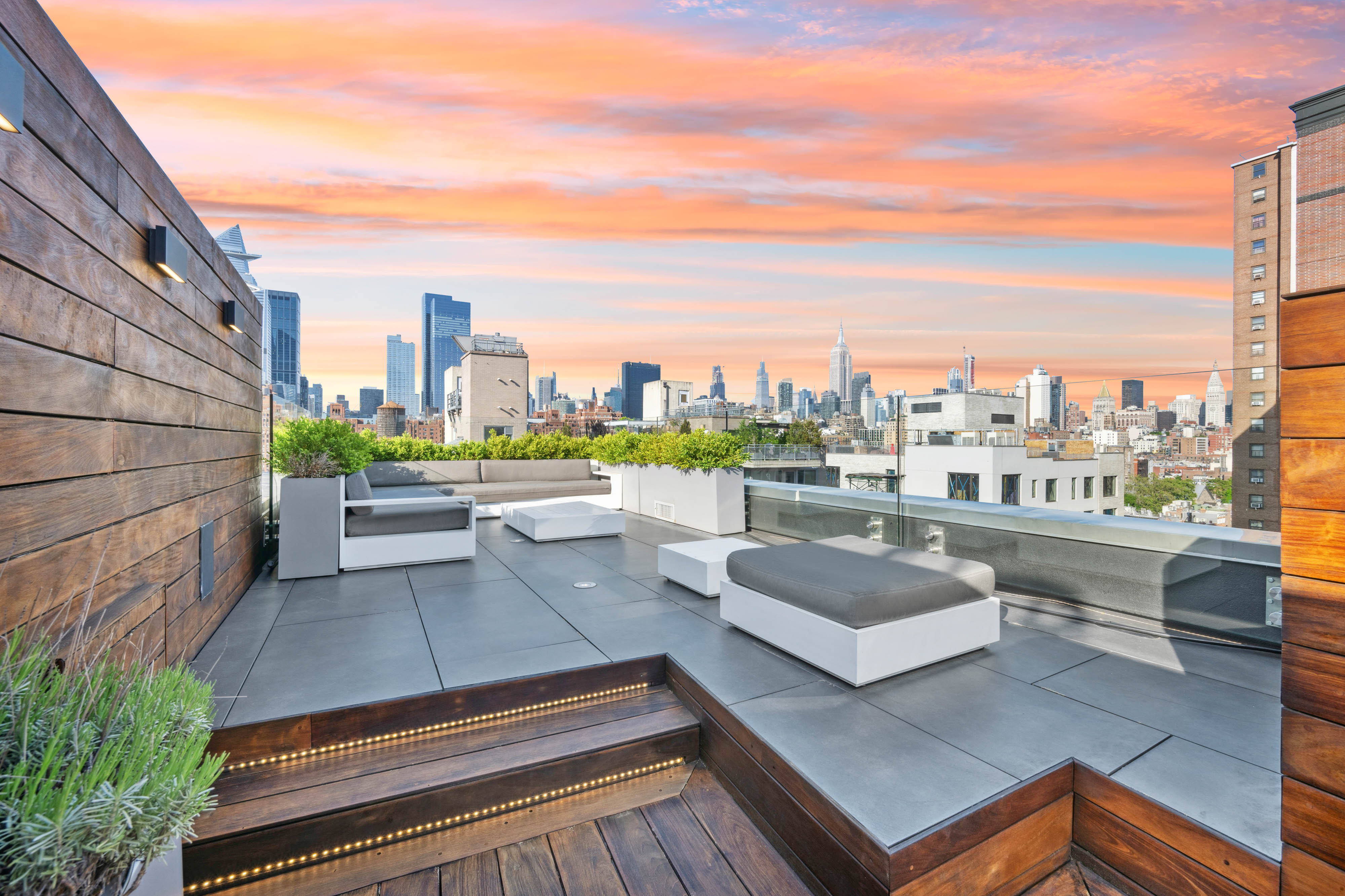 a view of roof deck with seating space and city view