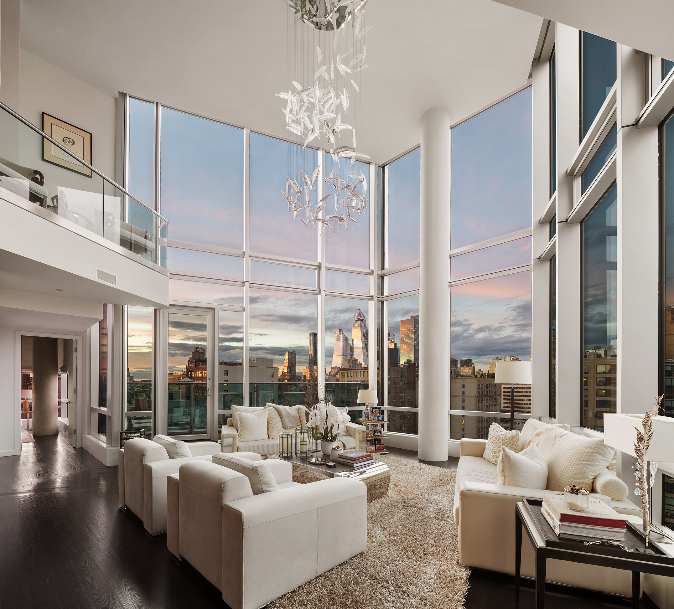 a living room with furniture and large windows