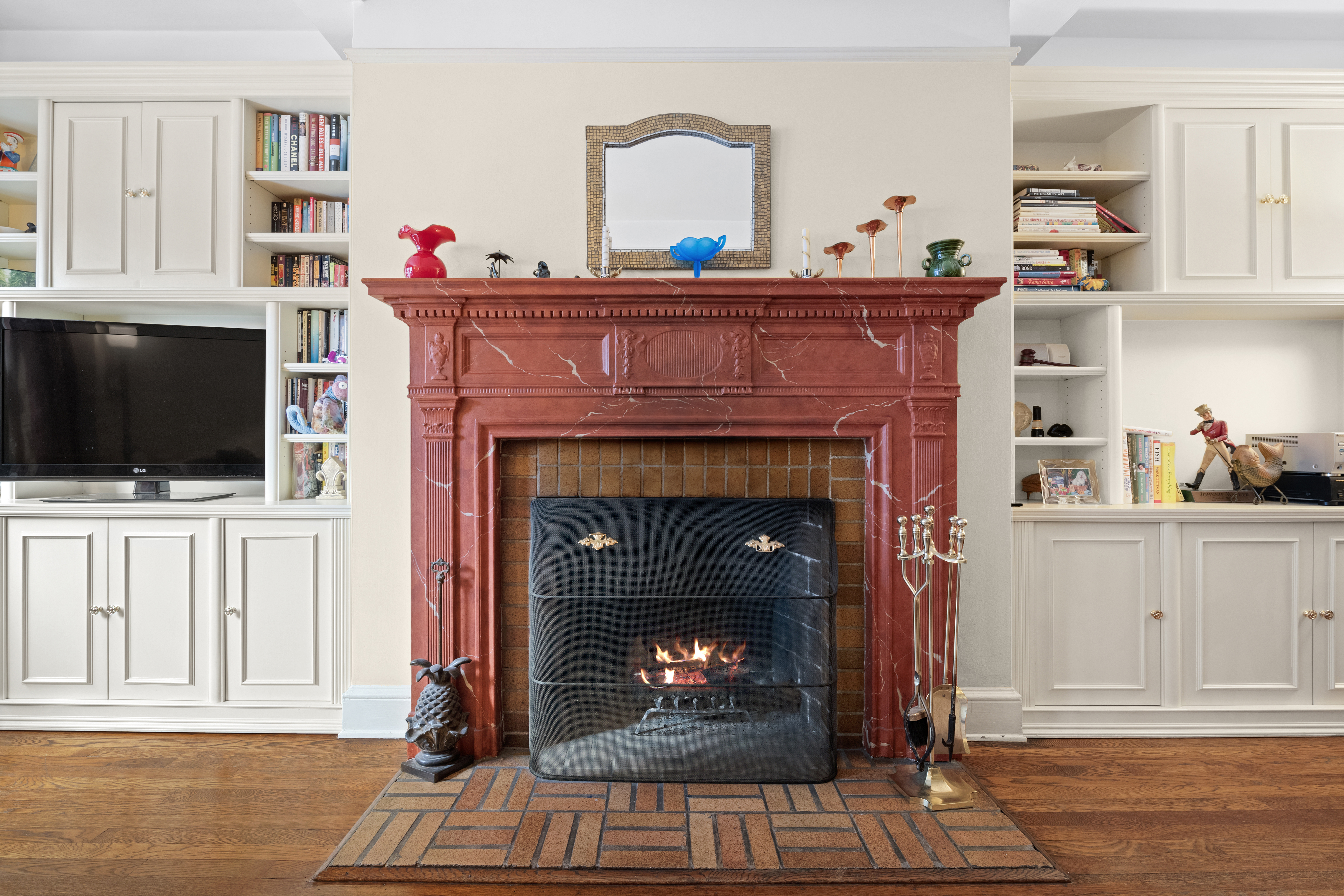 a living room with a fireplace and a flat screen tv