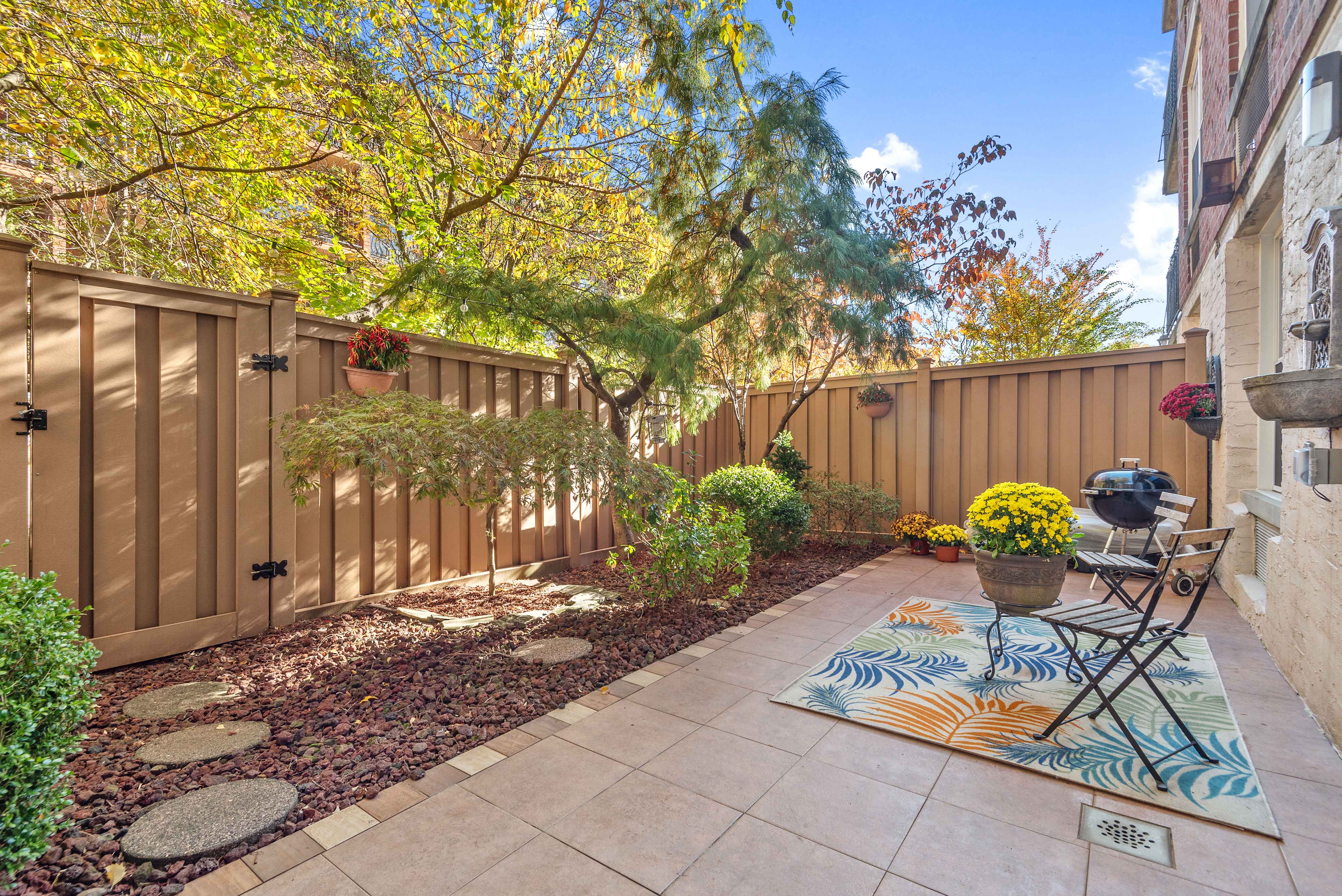 a view of a chair and table in backyard