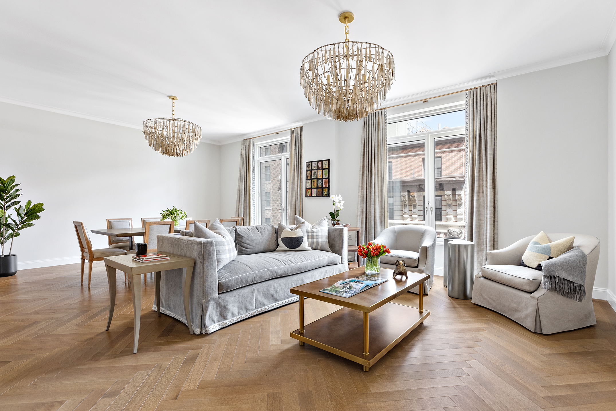 a living room with furniture chandelier and a table