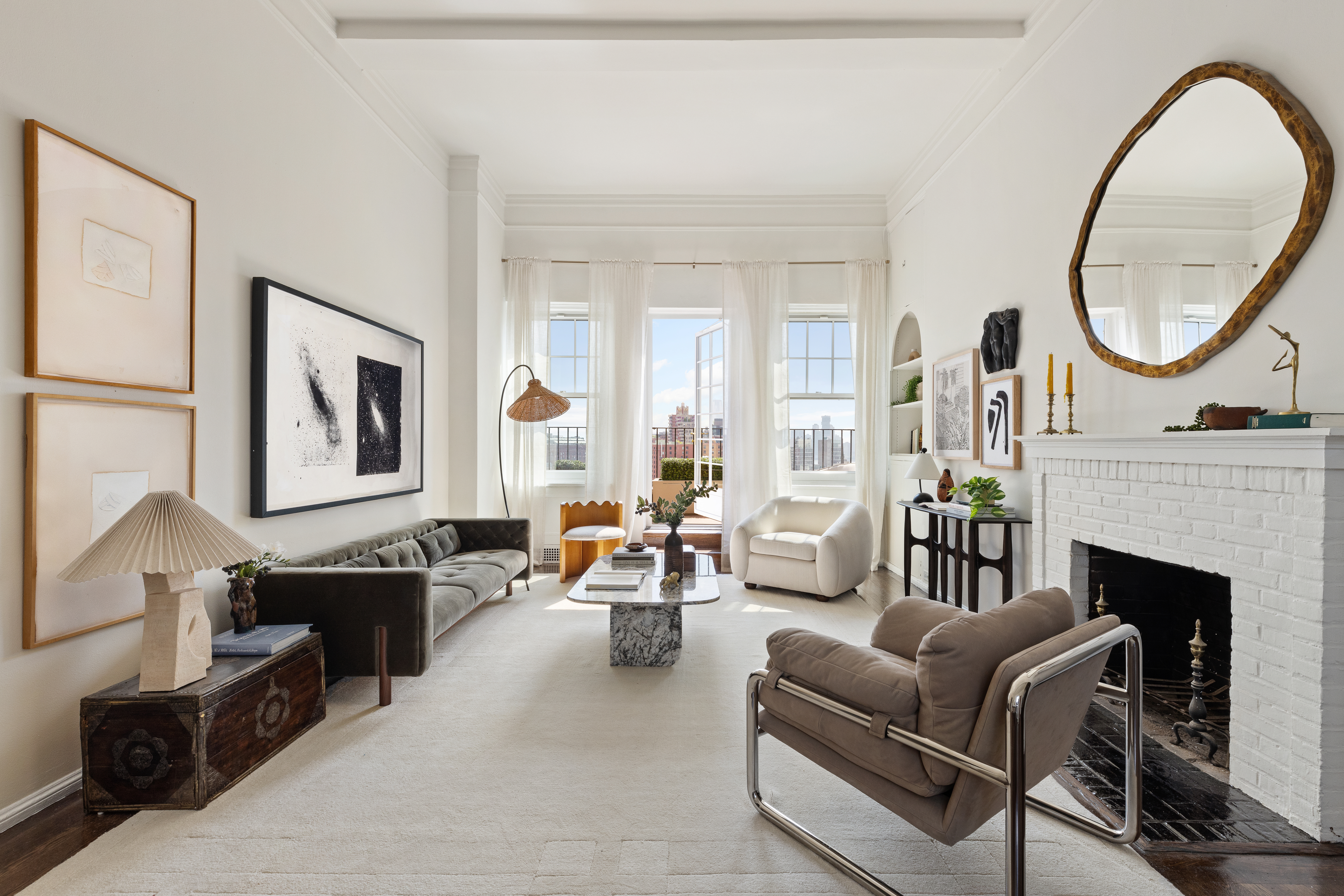 a living room with furniture a fireplace and a large window