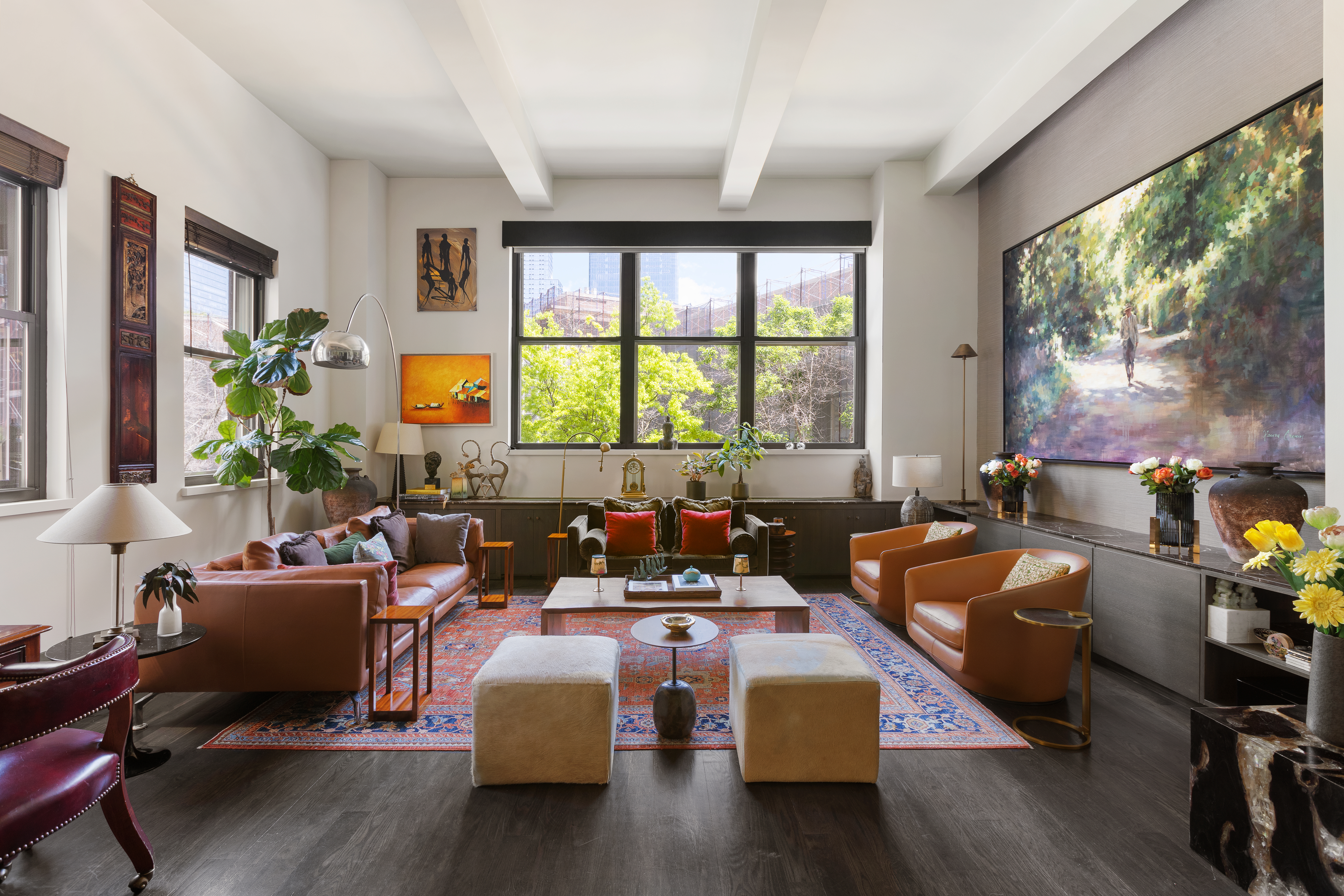 a living room with fireplace furniture and a large window