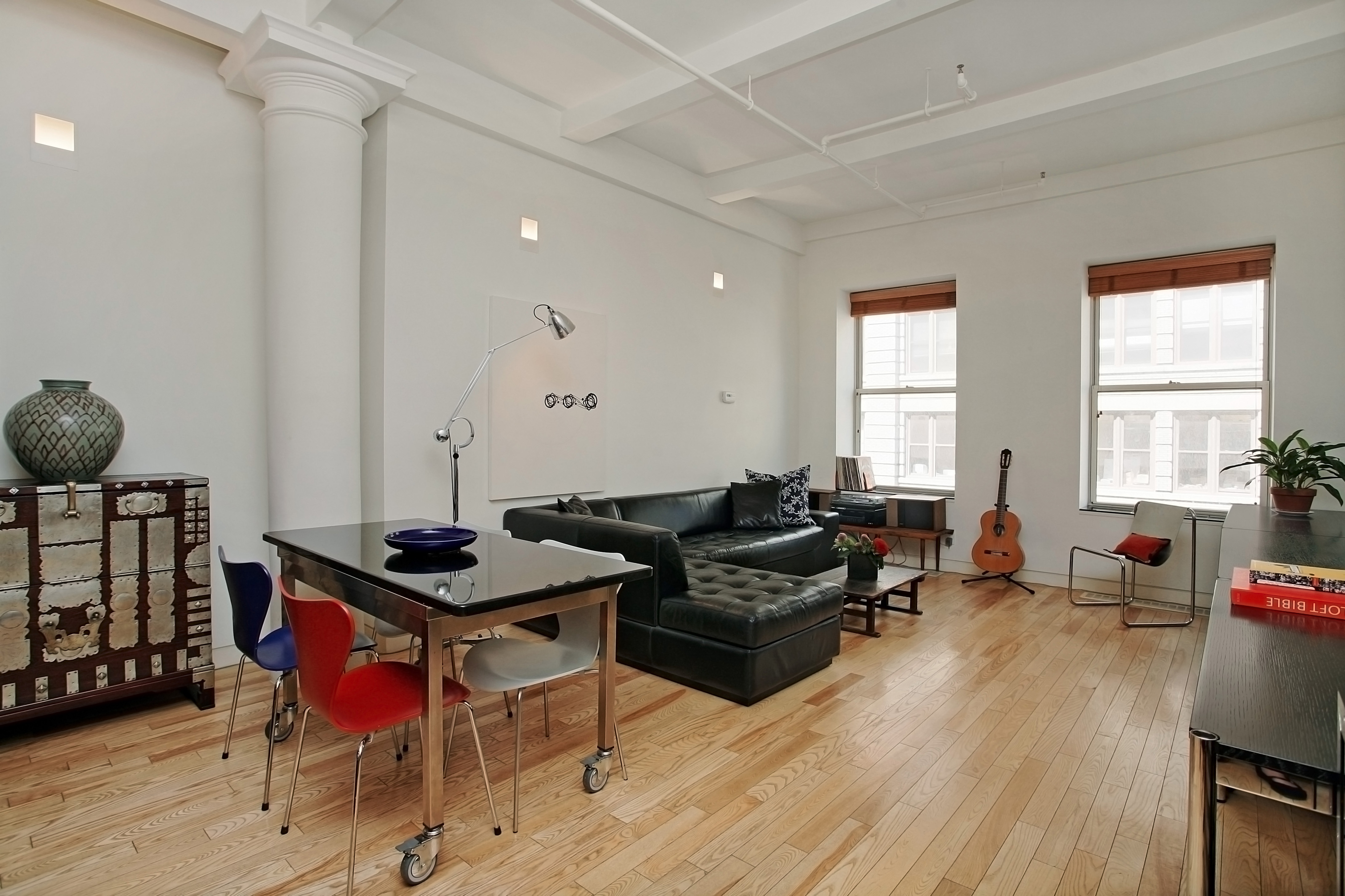 a living room with furniture a dining table and a wooden floor