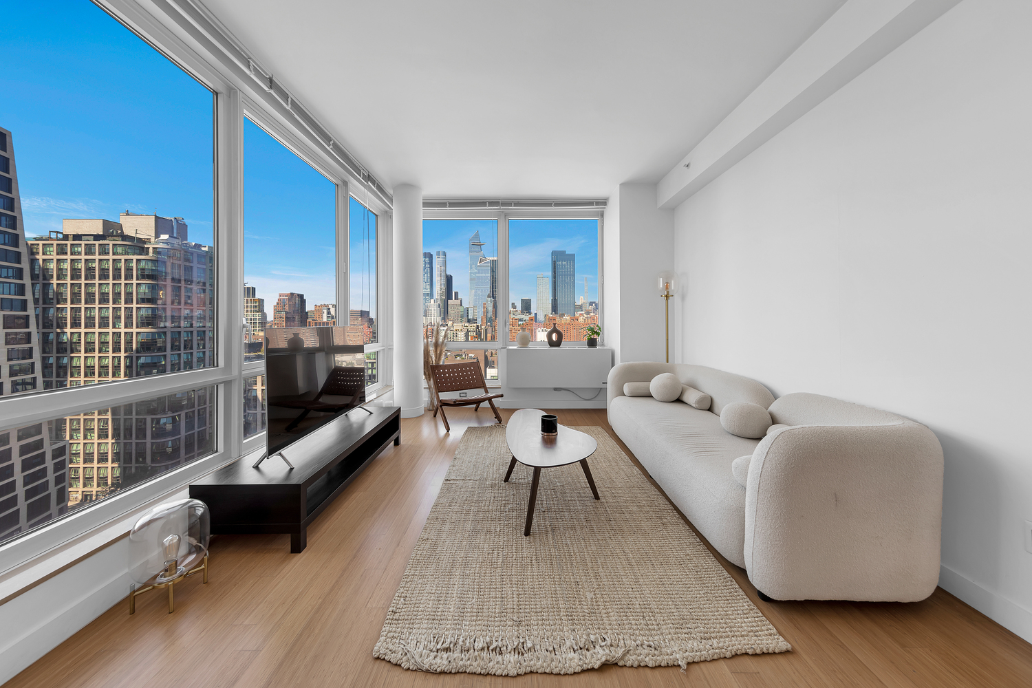 a living room with furniture rug and wooden floor