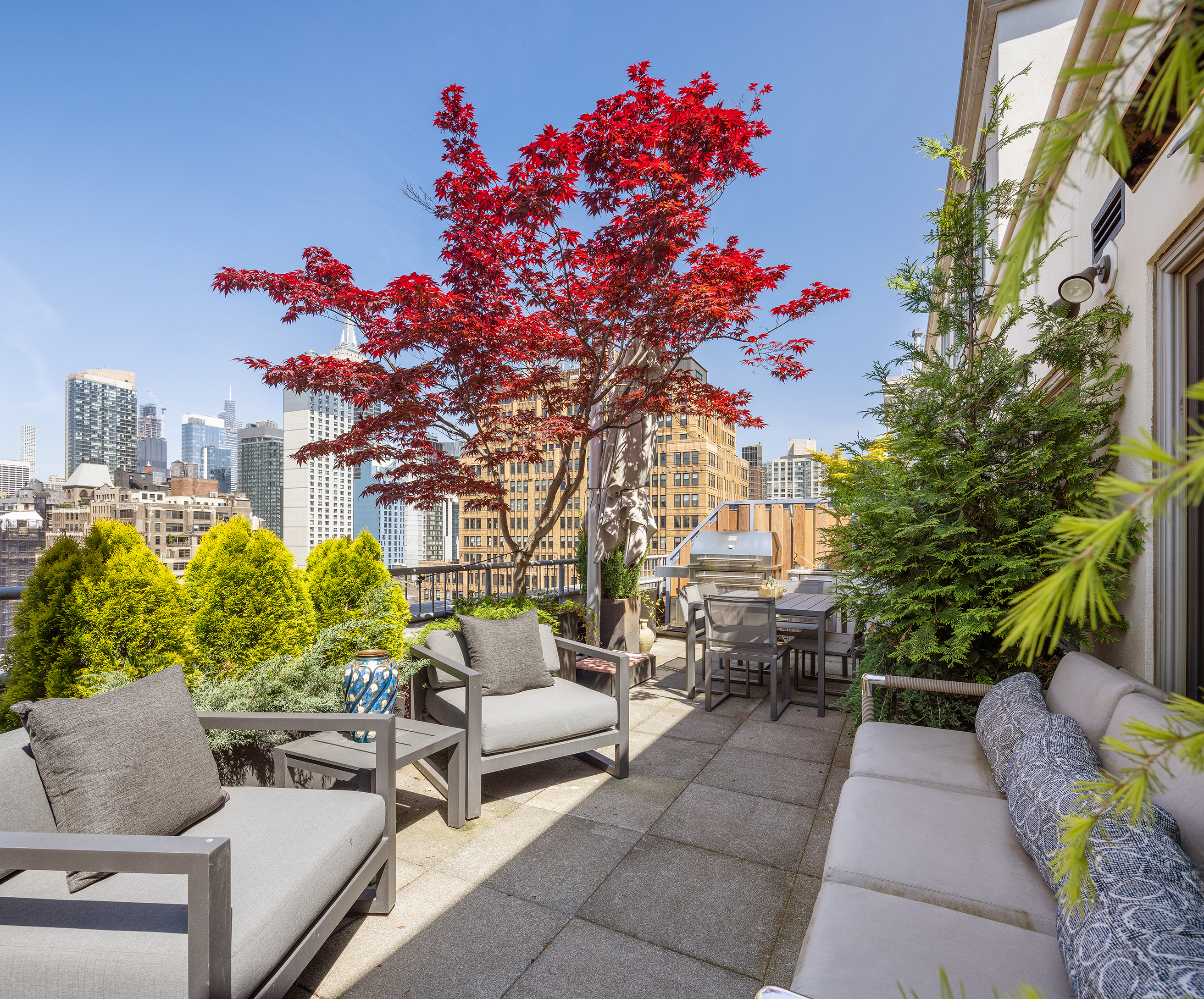 a view of a patio with couches table and chairs and potted plants