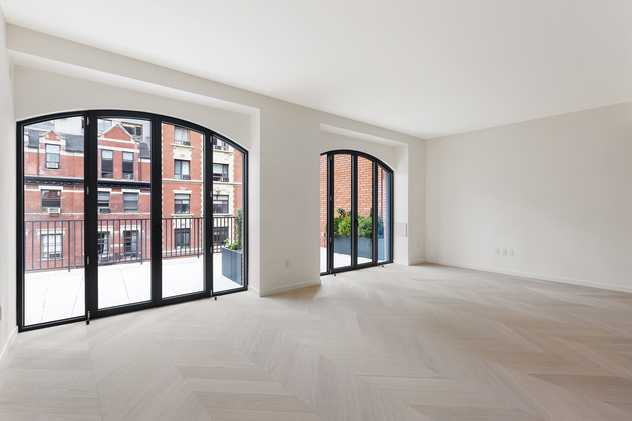 an empty room with windows and pool table