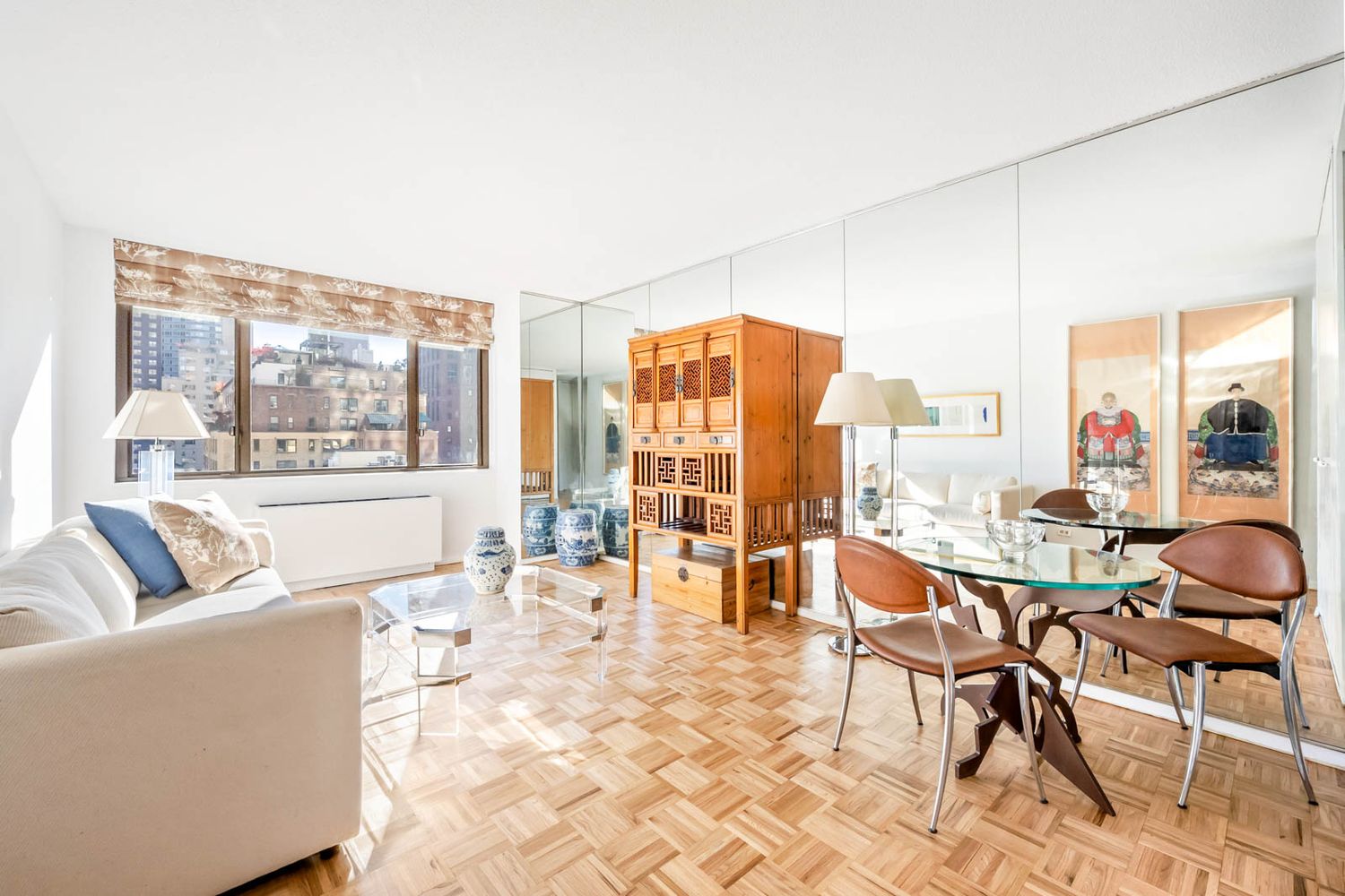 a living room with furniture and large windows