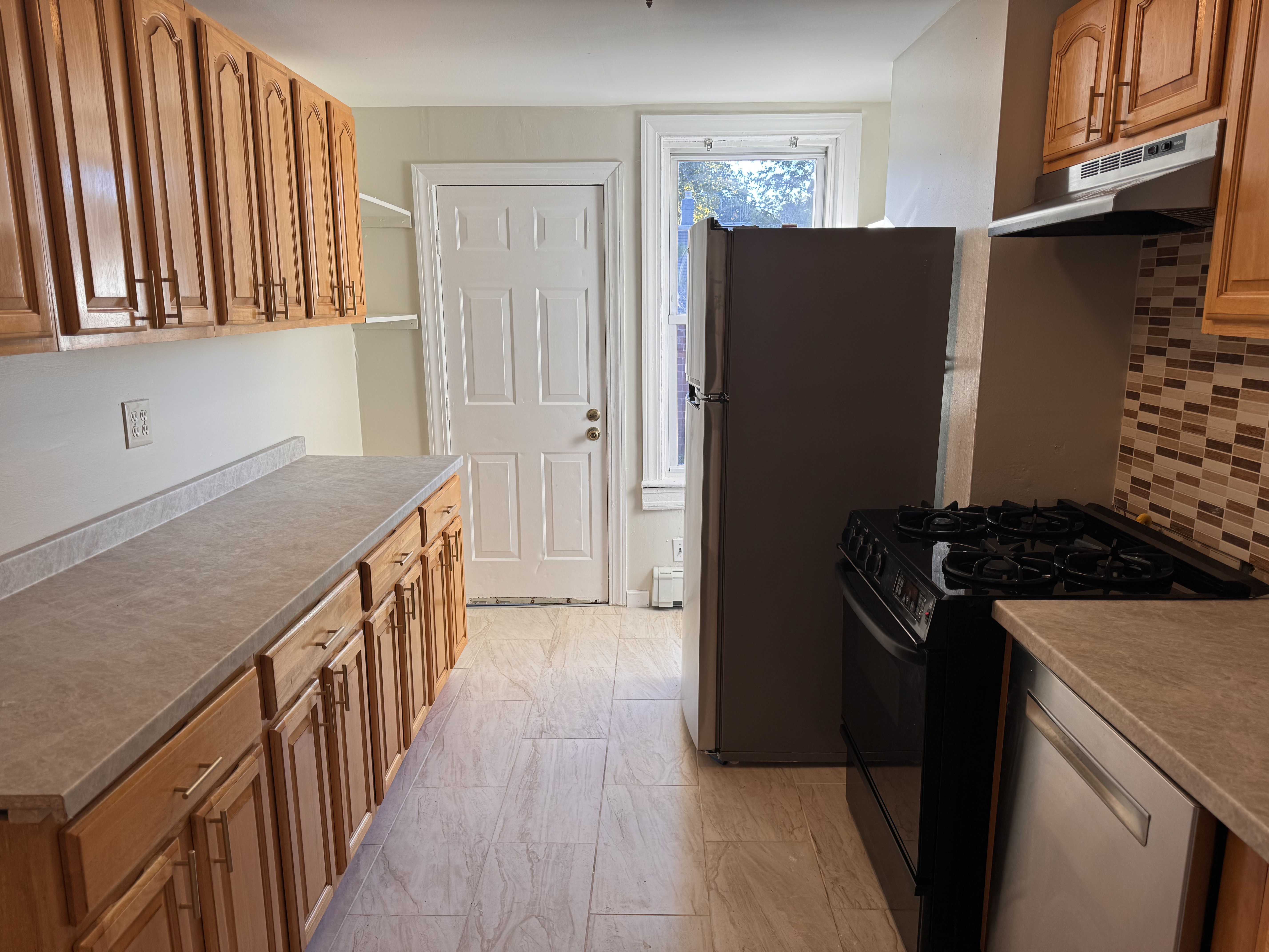 a kitchen with a stove and a refrigerator