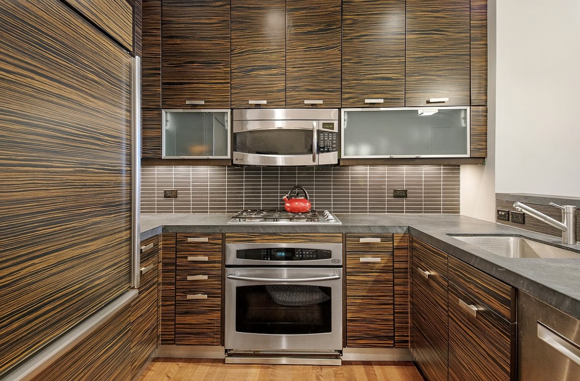 a stove top oven sitting inside of a kitchen