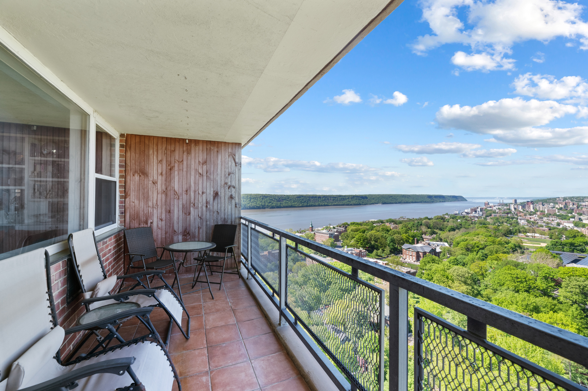 a view of a chairs and table in a balcony