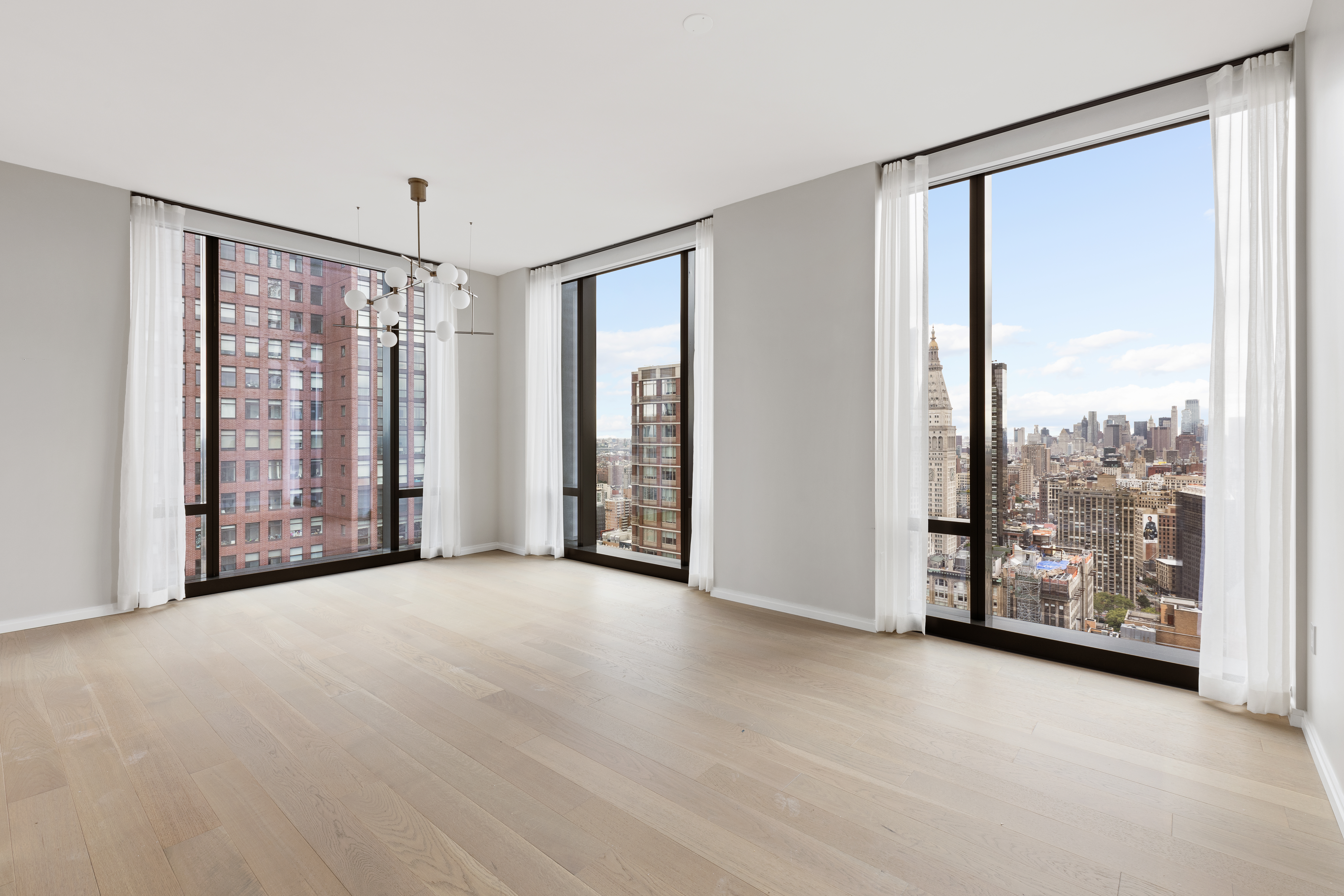 an empty room with windows and city view