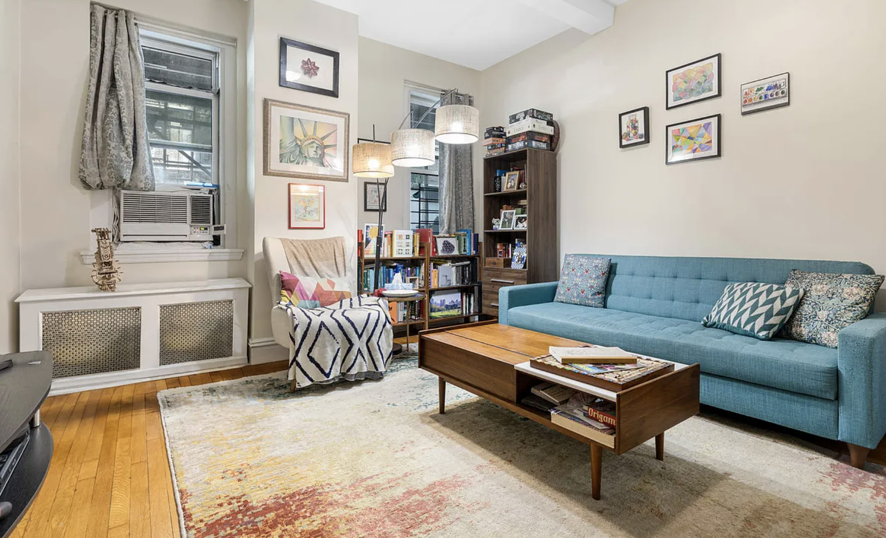 a living room with a couch and a book shelf