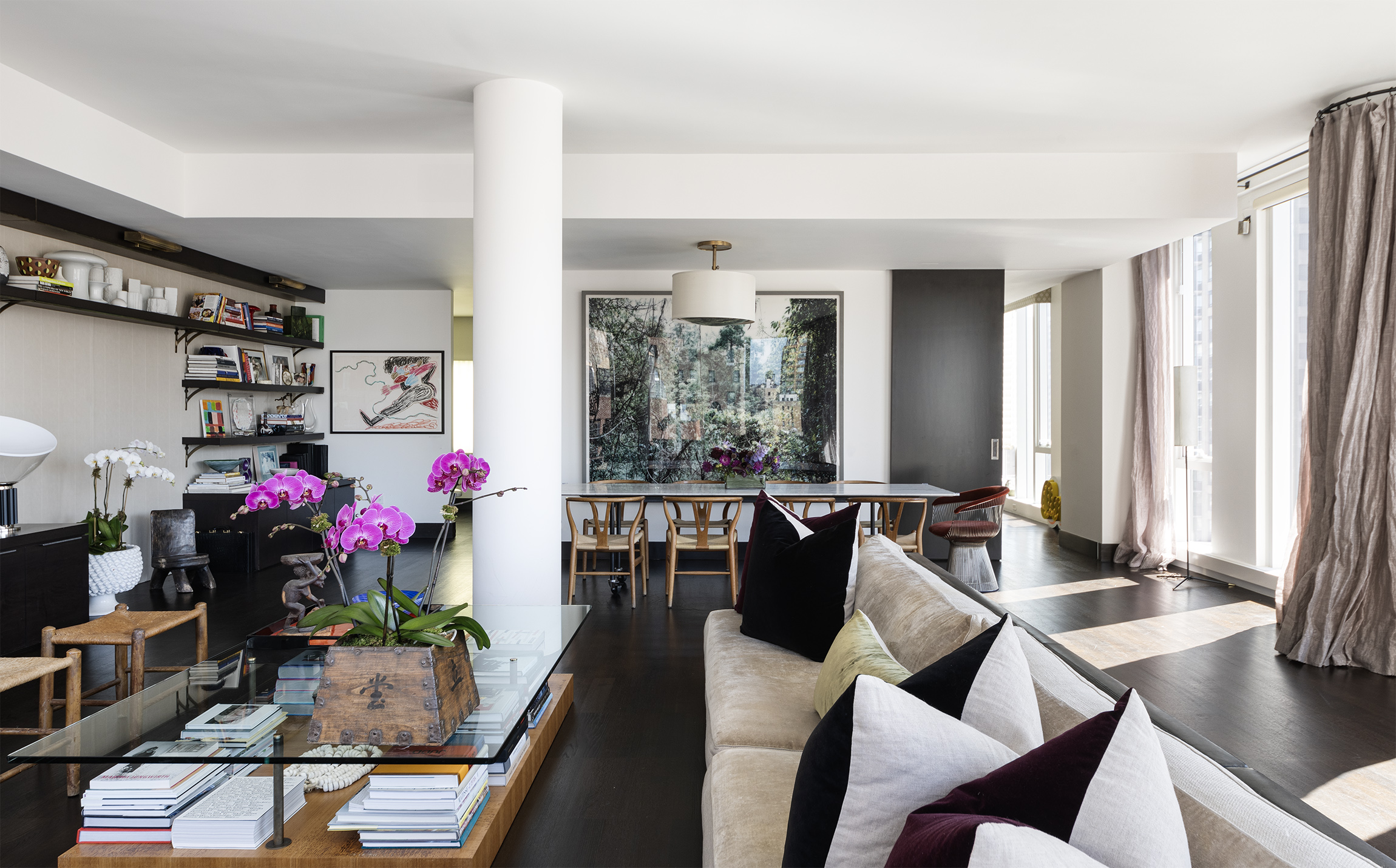 a living room filled with furniture and a potted plant