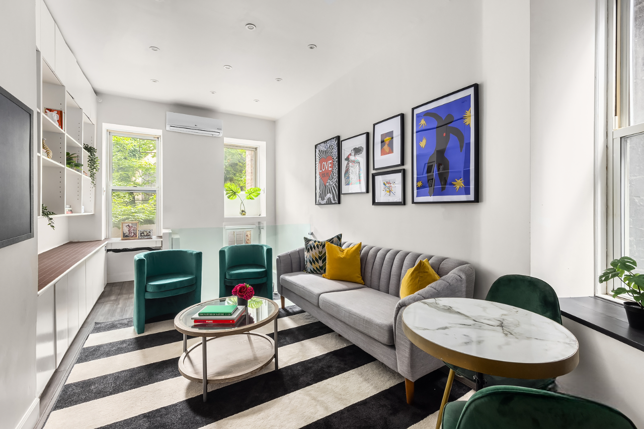 a living room with furniture and a potted plant