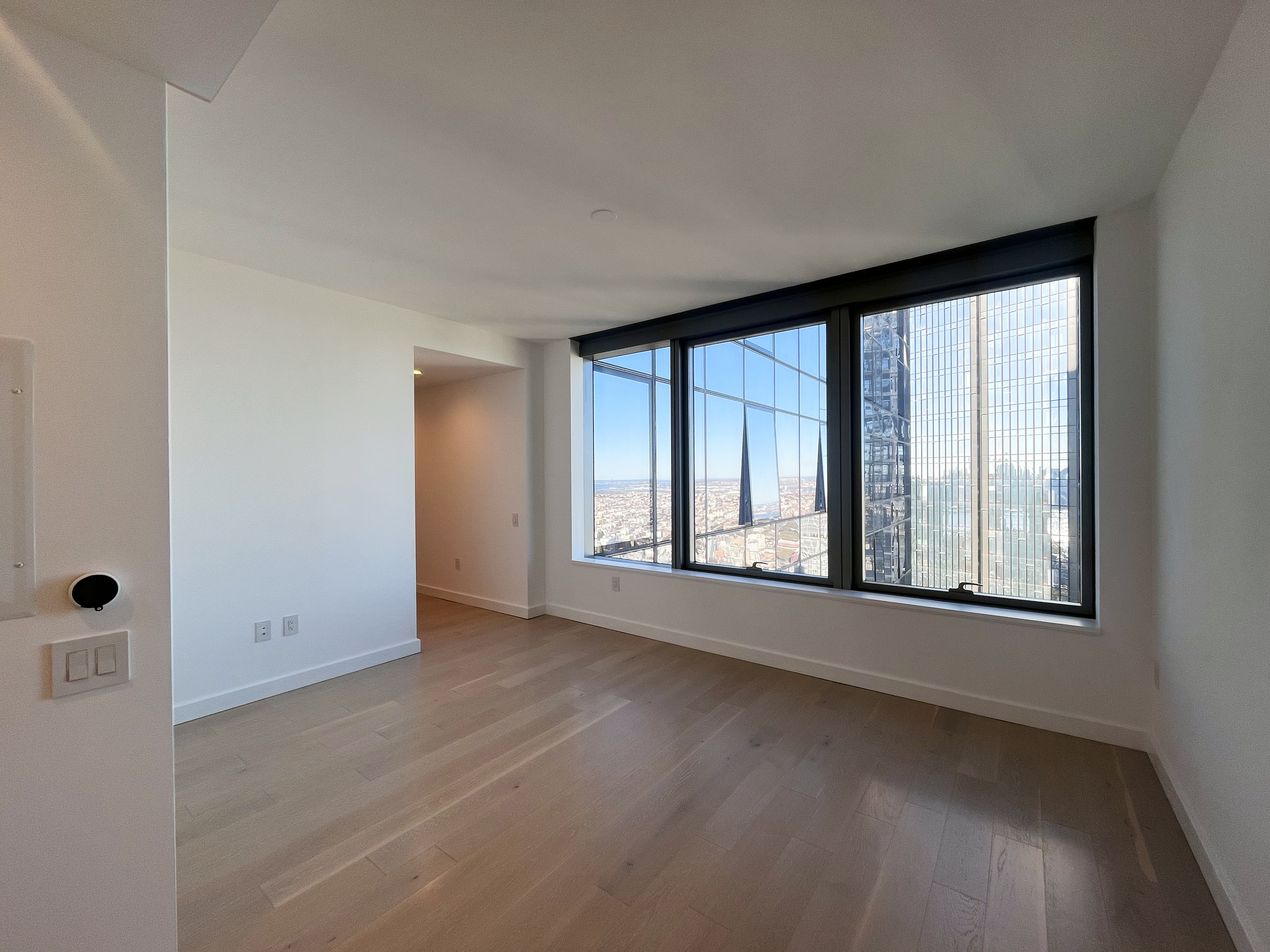 an empty room with windows and closet