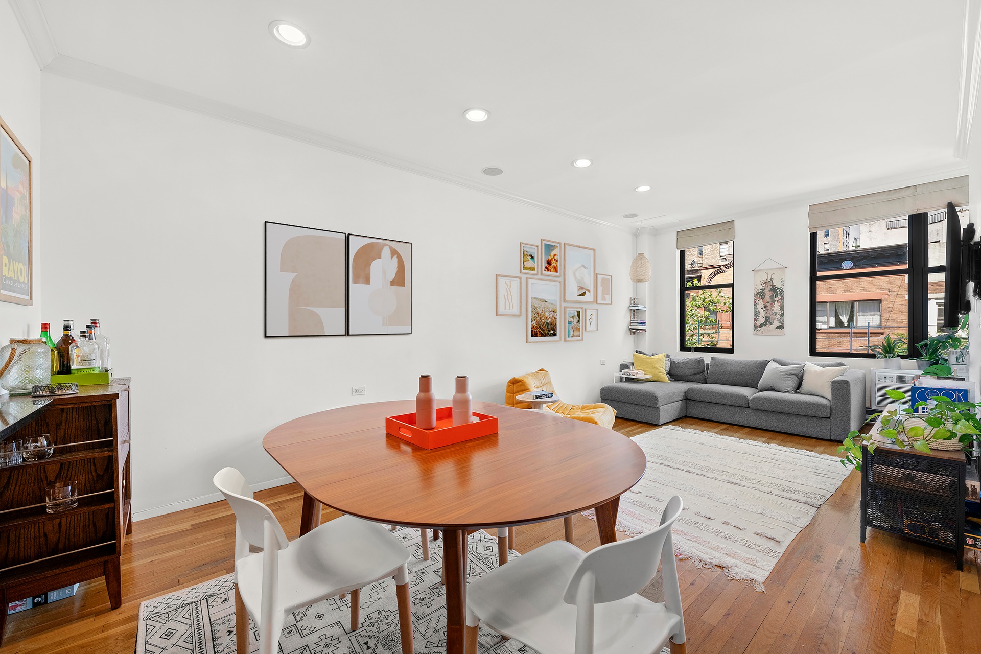 a living room with furniture kitchen view and a table