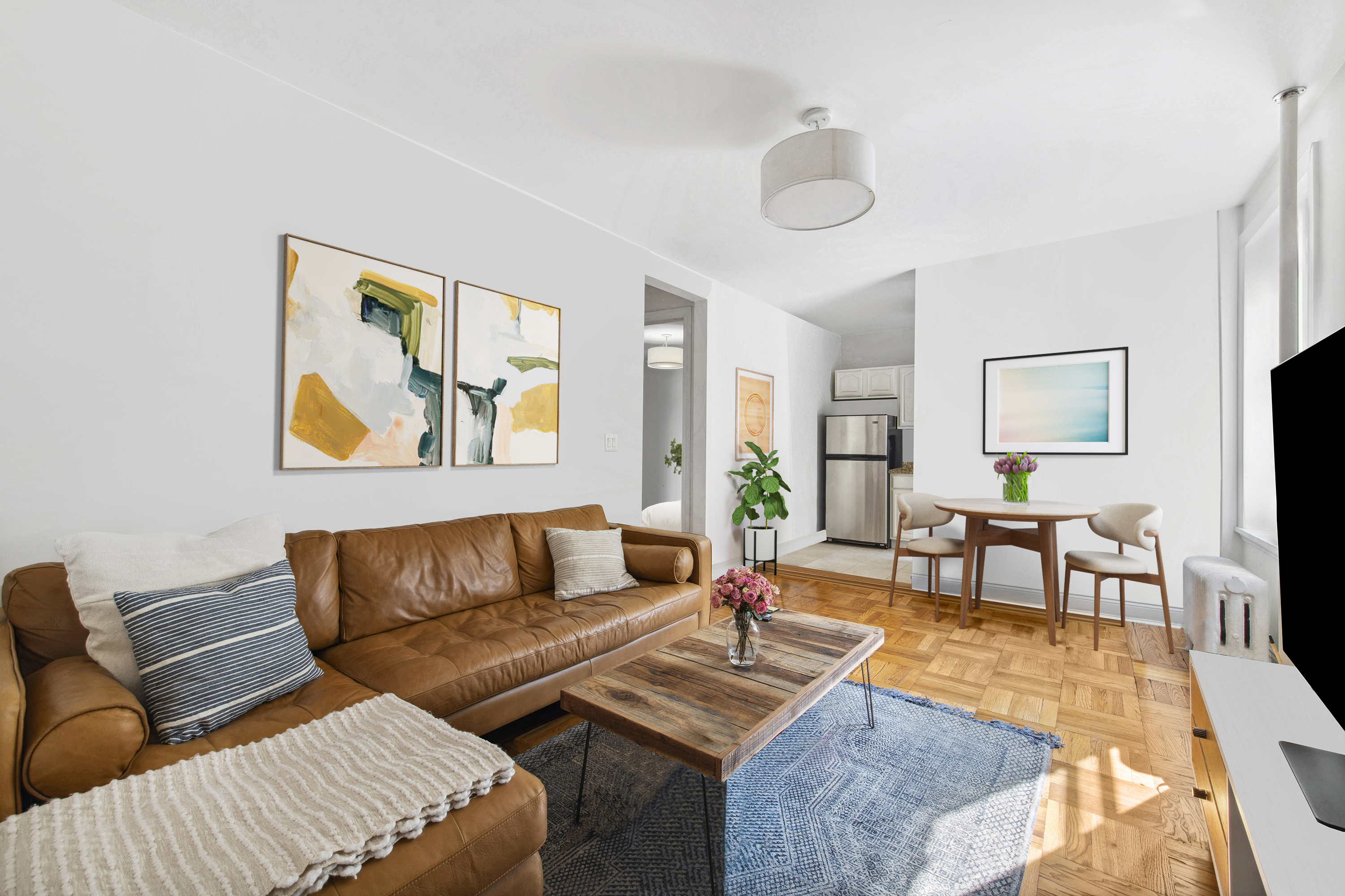 a living room with furniture and wooden floor