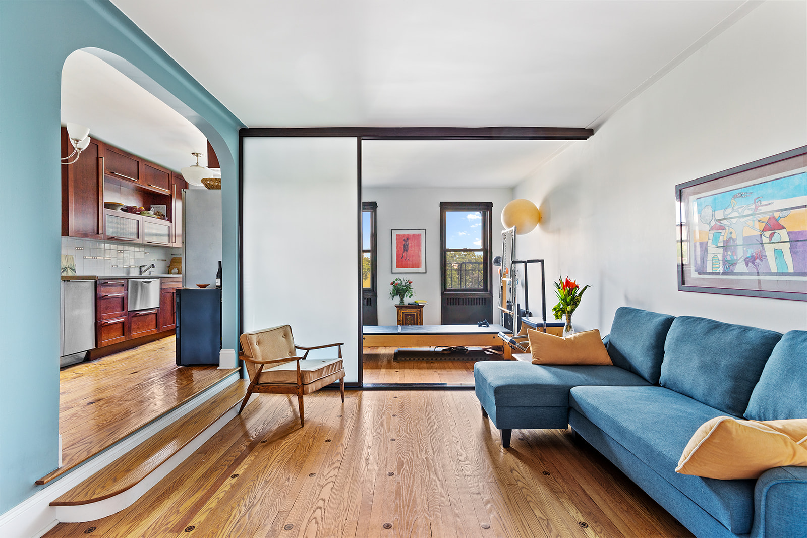 a living room with furniture and a wooden floor