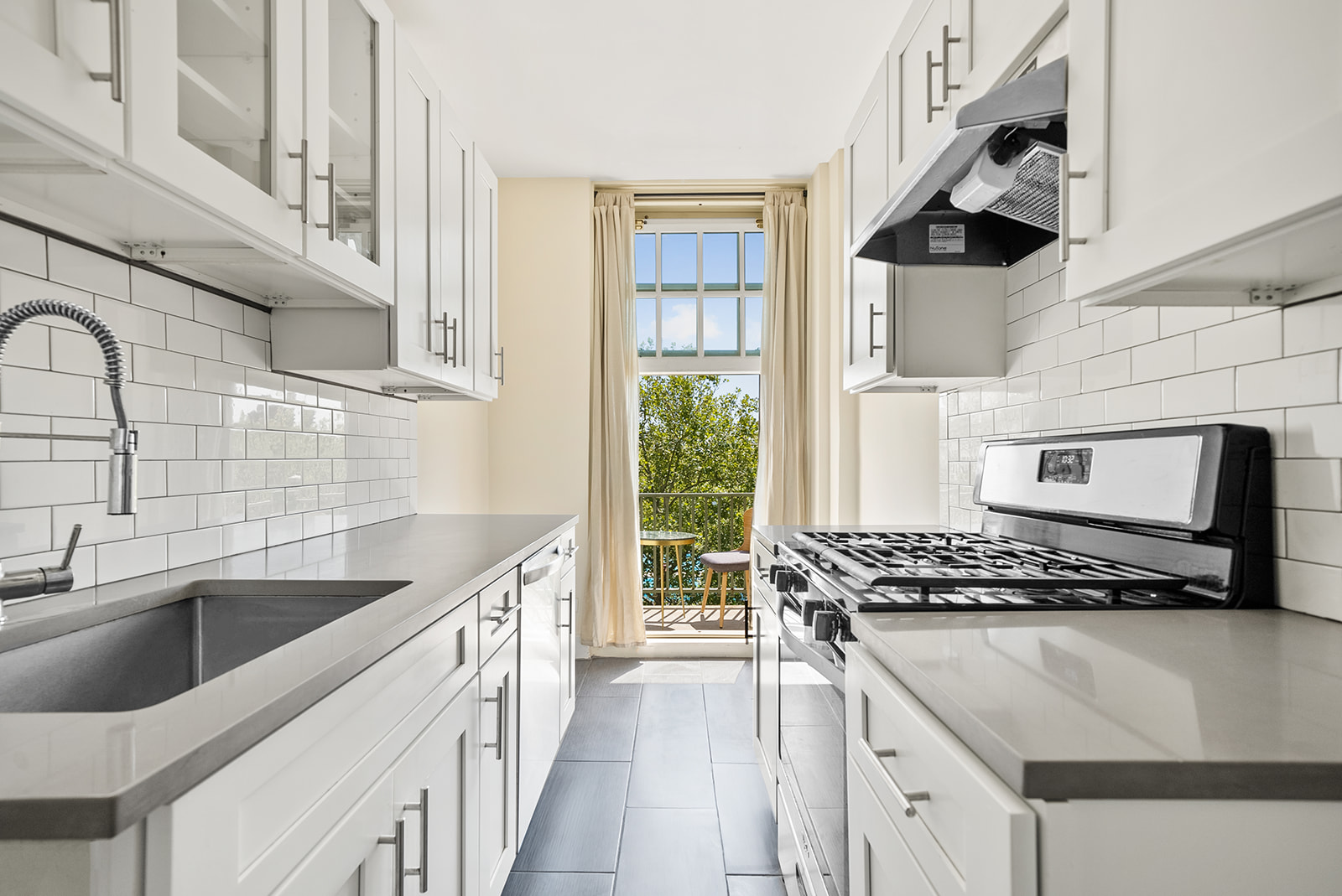 a kitchen with stainless steel appliances a sink a stove and a refrigerator