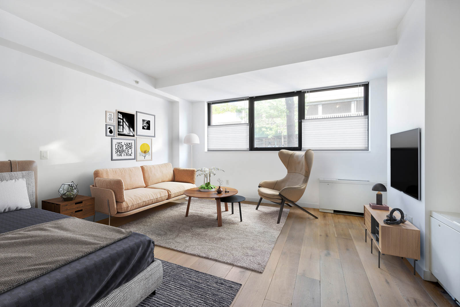 a living room with furniture wooden floor and a flat screen tv