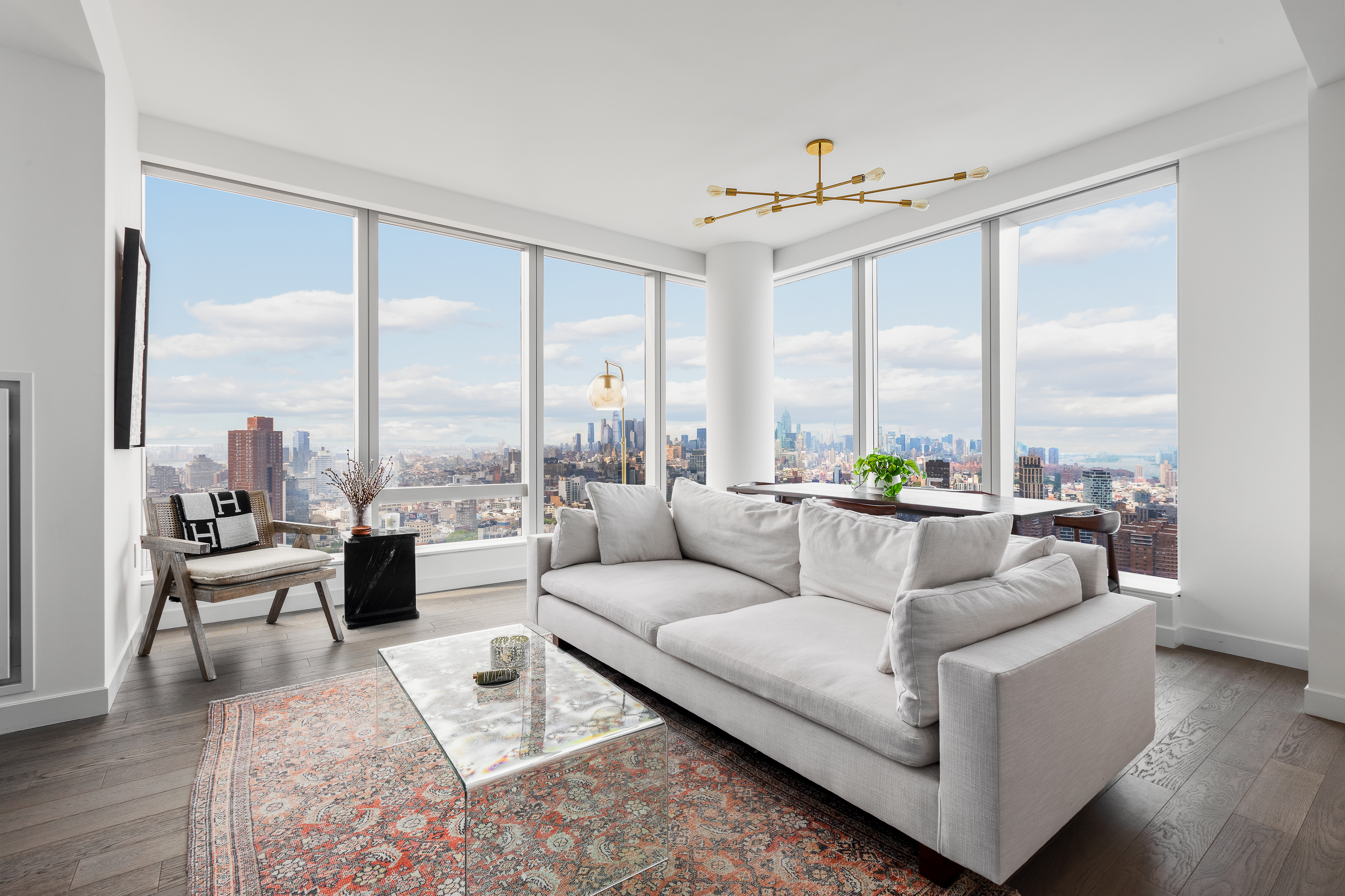 a living room with furniture city view and large windows