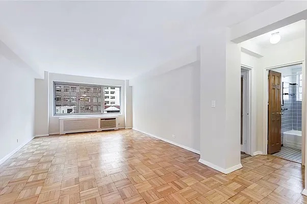 a view of a big room with windows and cabinet