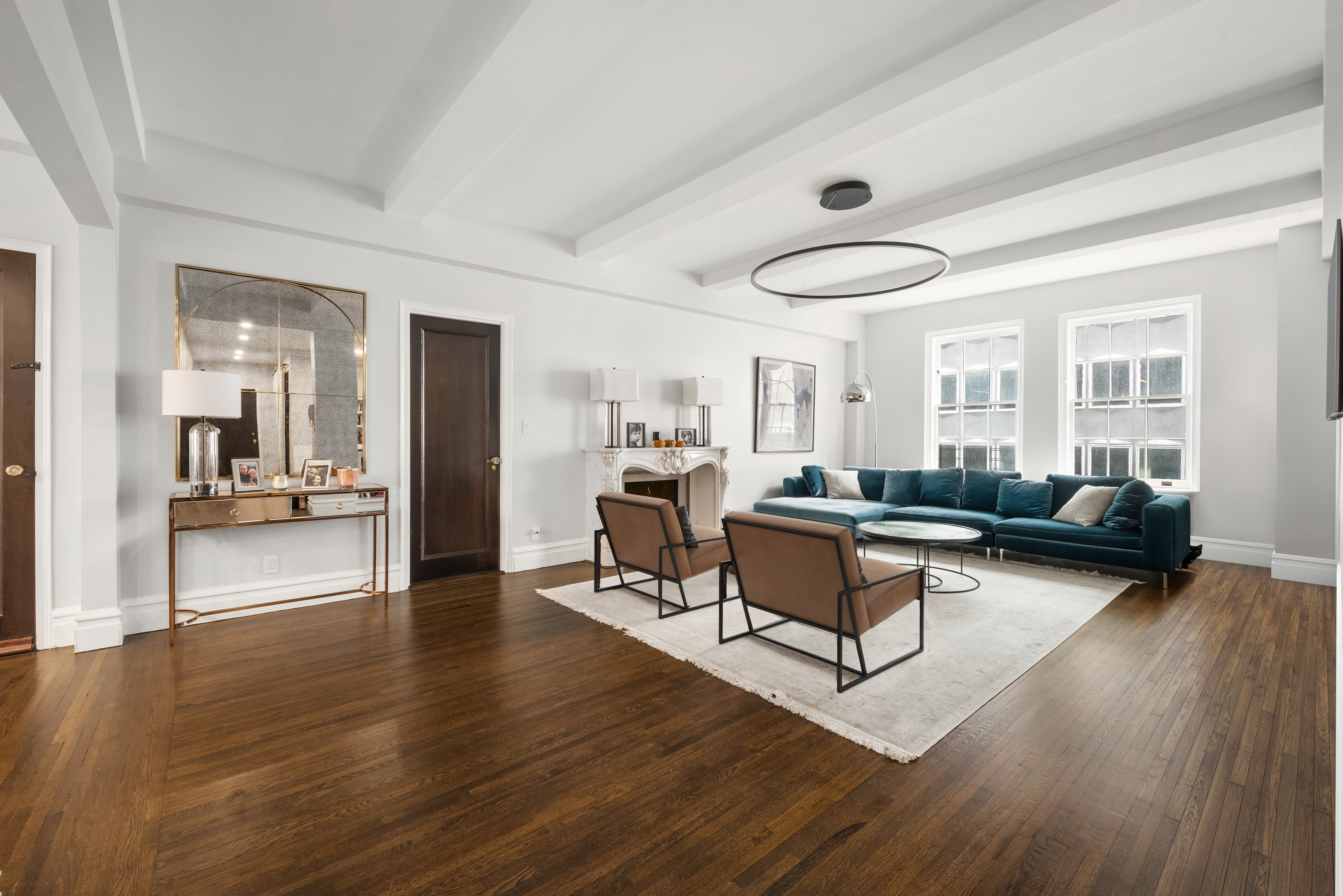 a living room with furniture and a wooden floor