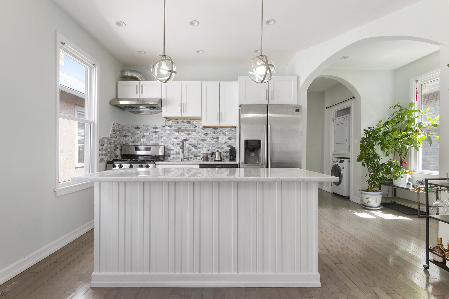 a kitchen with stainless steel appliances kitchen island granite countertop a table and chairs in it