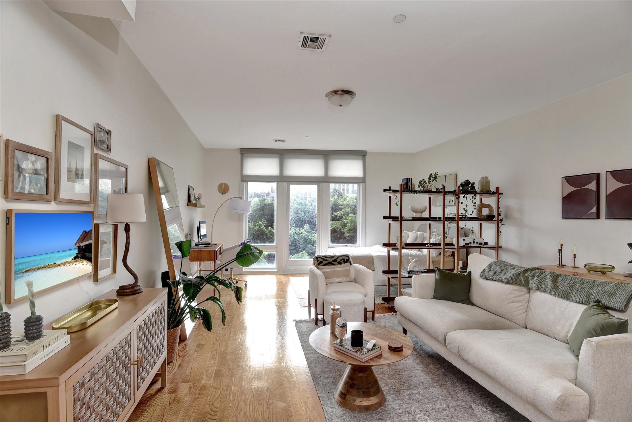 a living room with furniture wooden floor and a large window