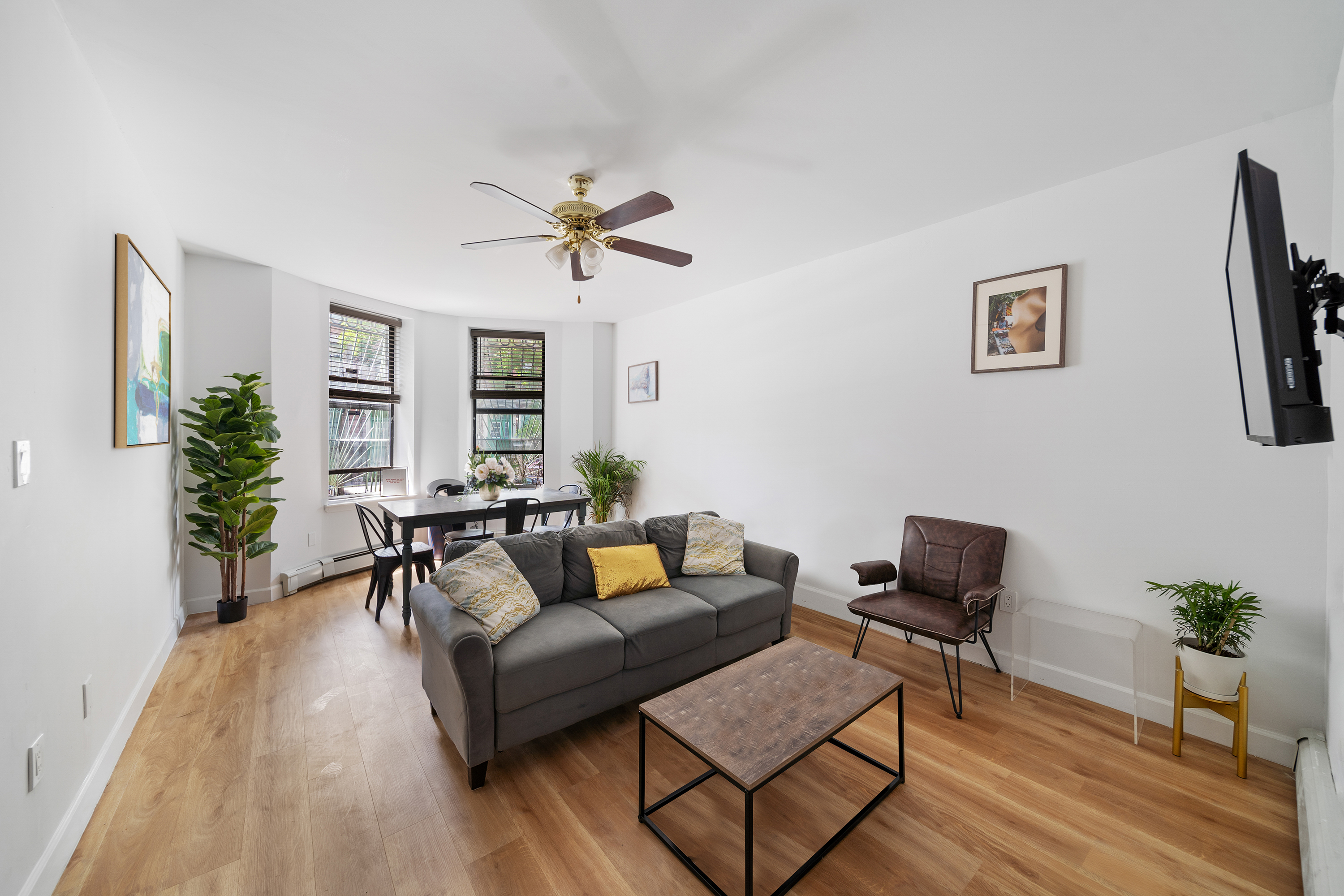 a living room with furniture and a wooden floor