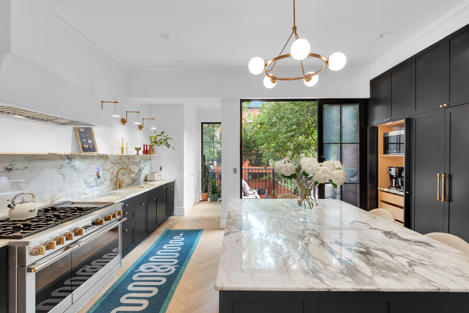 a kitchen with stove and a dining table