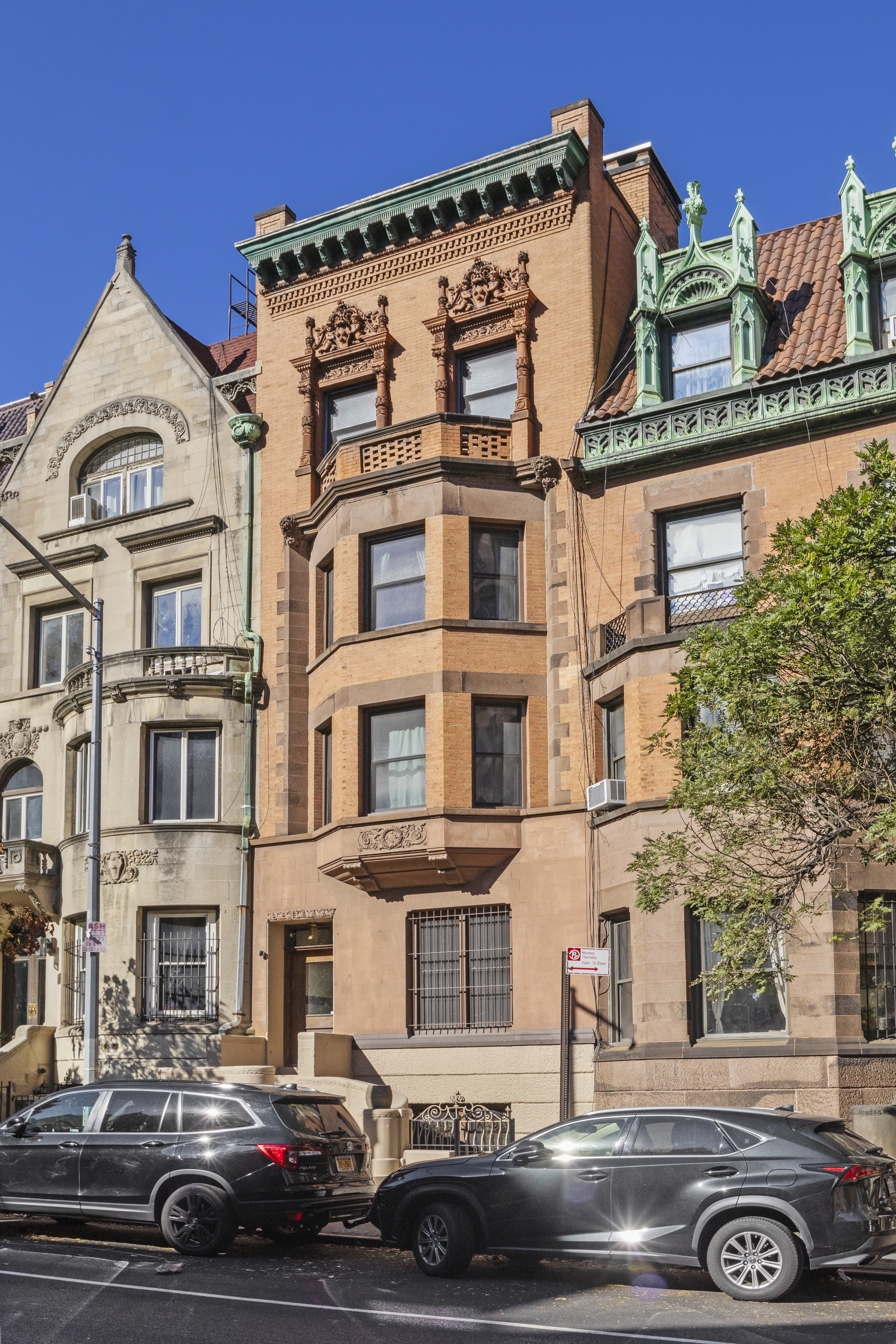 a front view of a residential apartment building with a yard