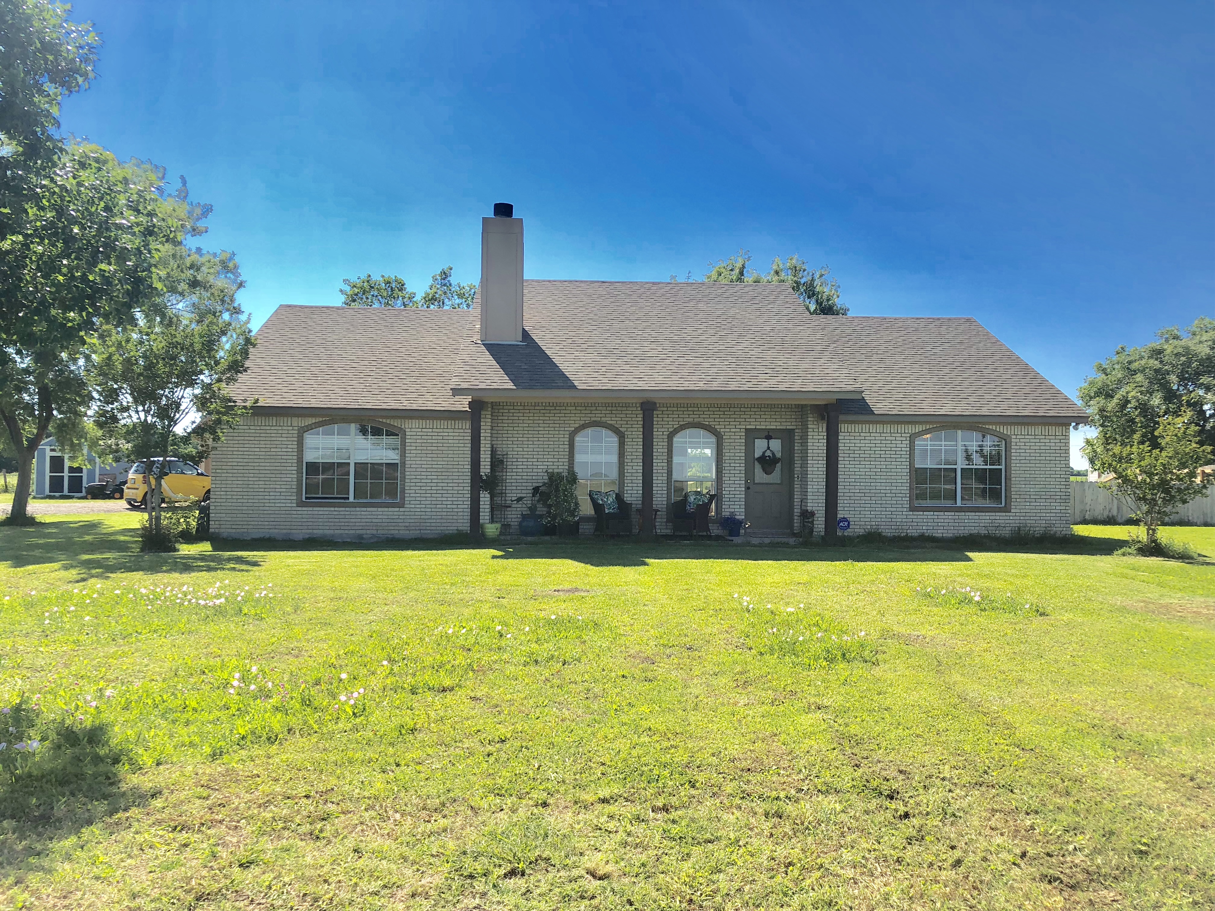 a front view of a house with a yard