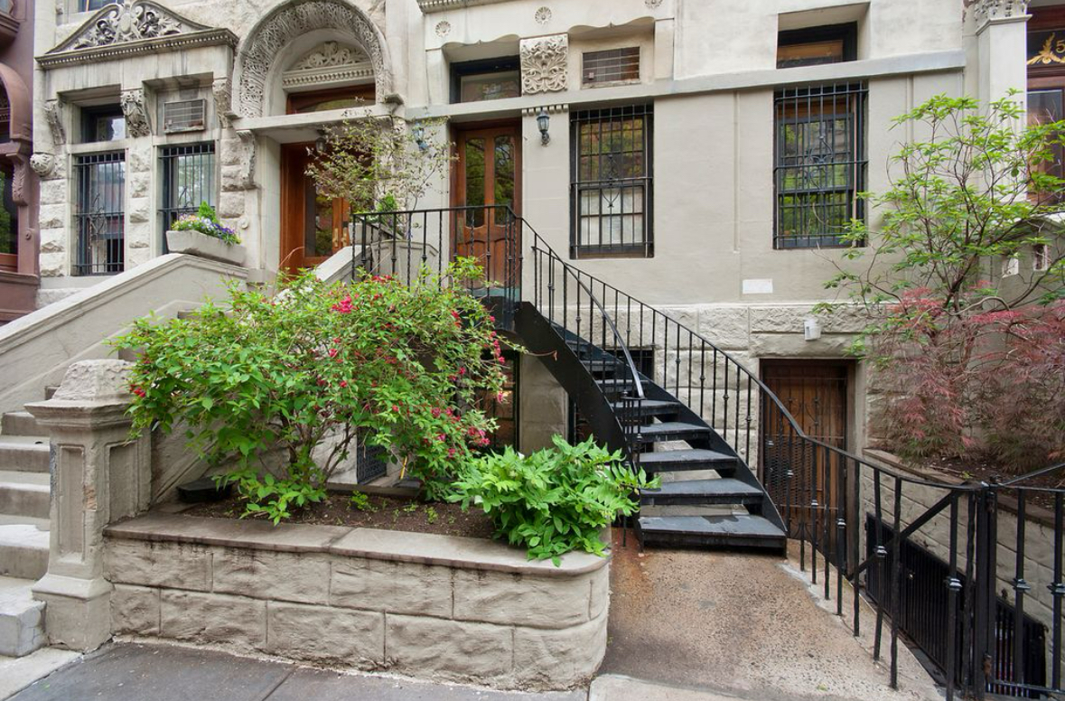 a view of a house with iron fence