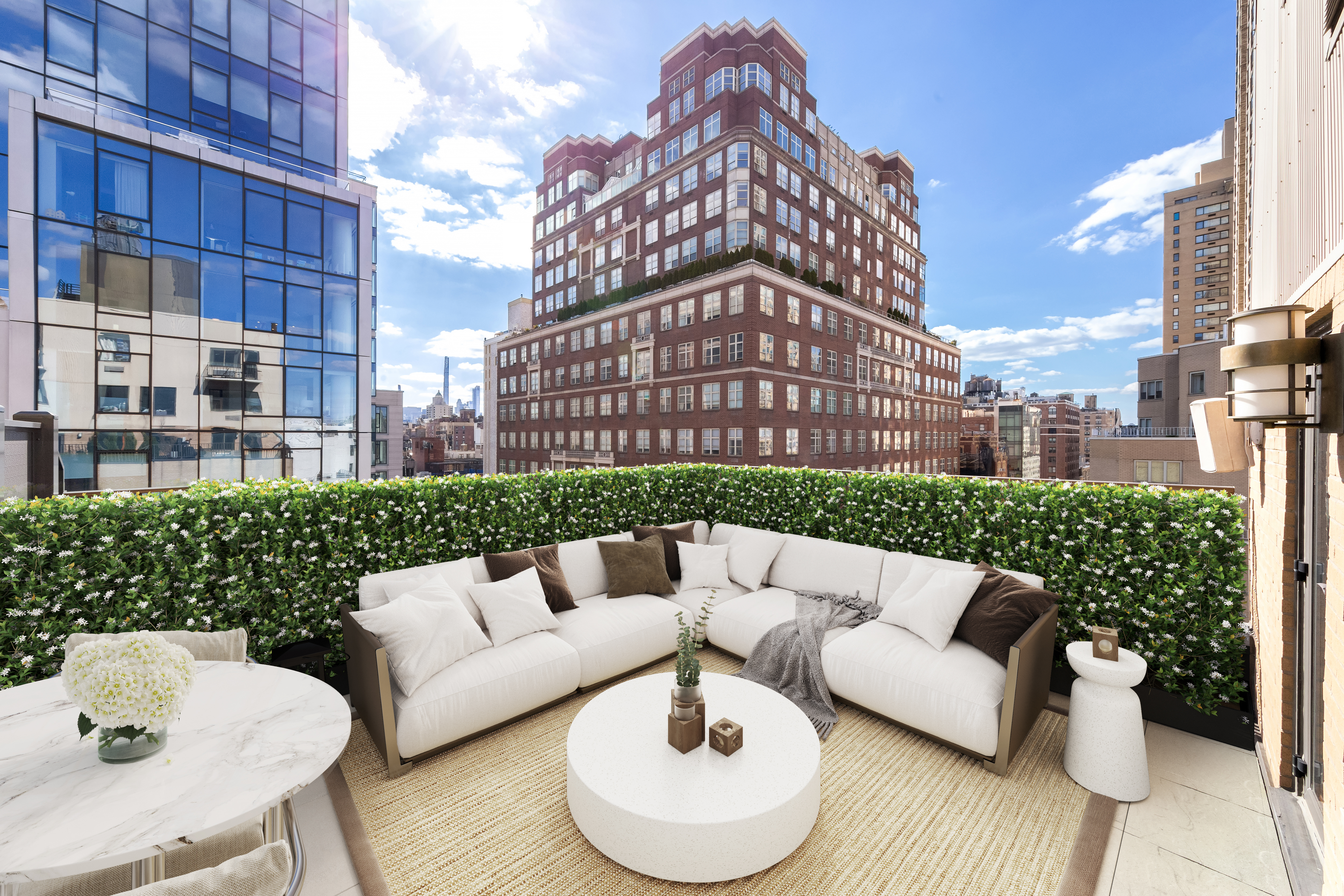 a view of a roof deck with couches and a potted plant on a table