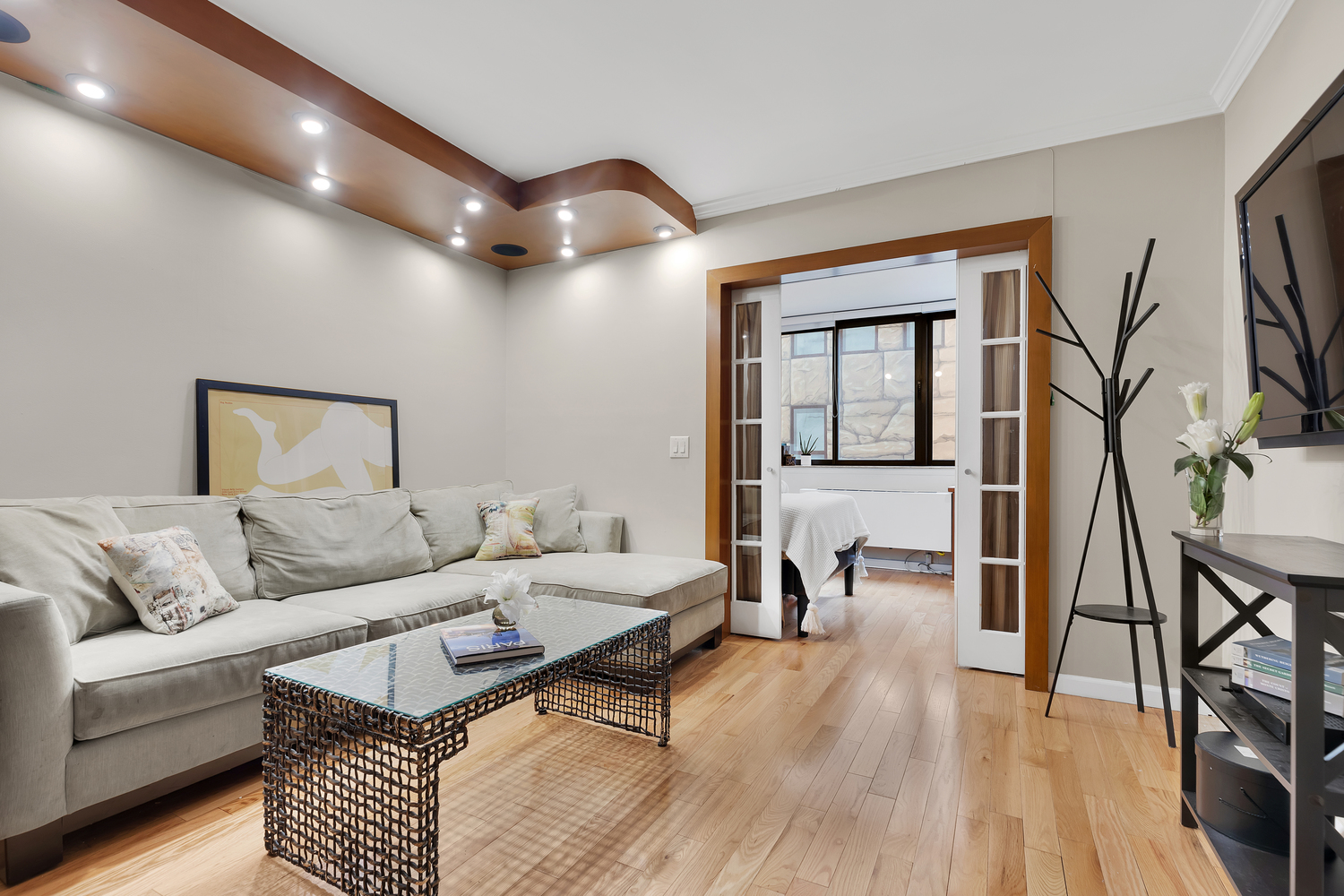 a living room with furniture and a wooden floor