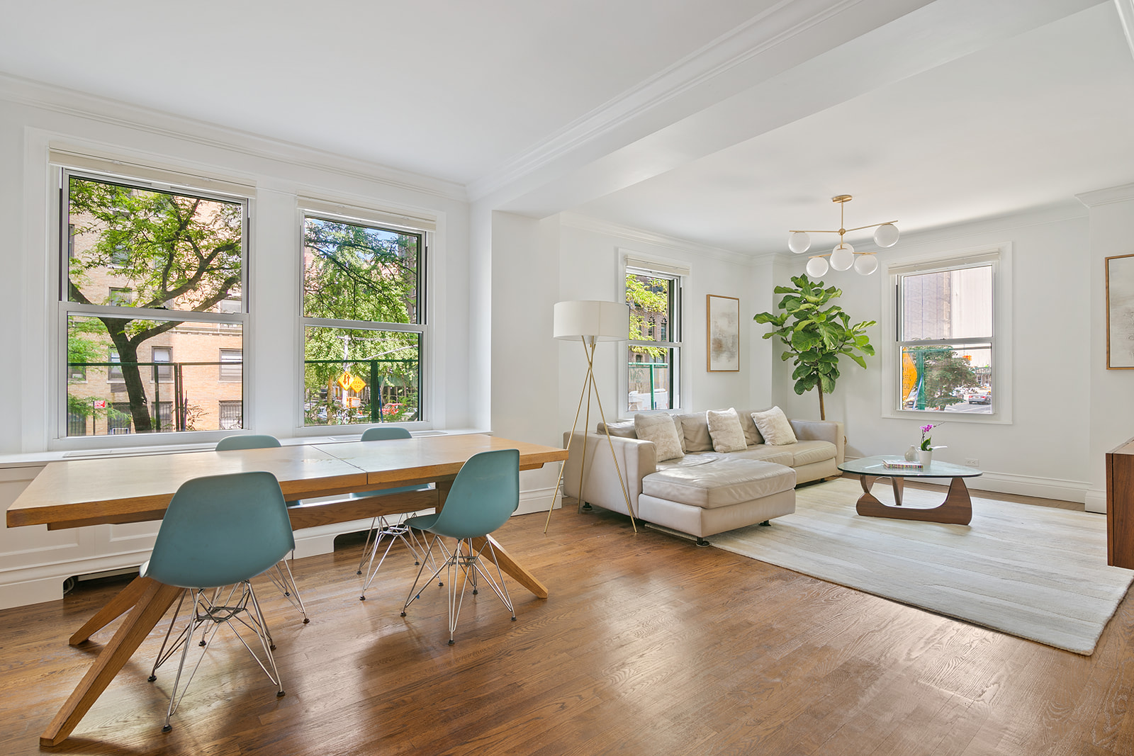 a living room with furniture and wooden floor