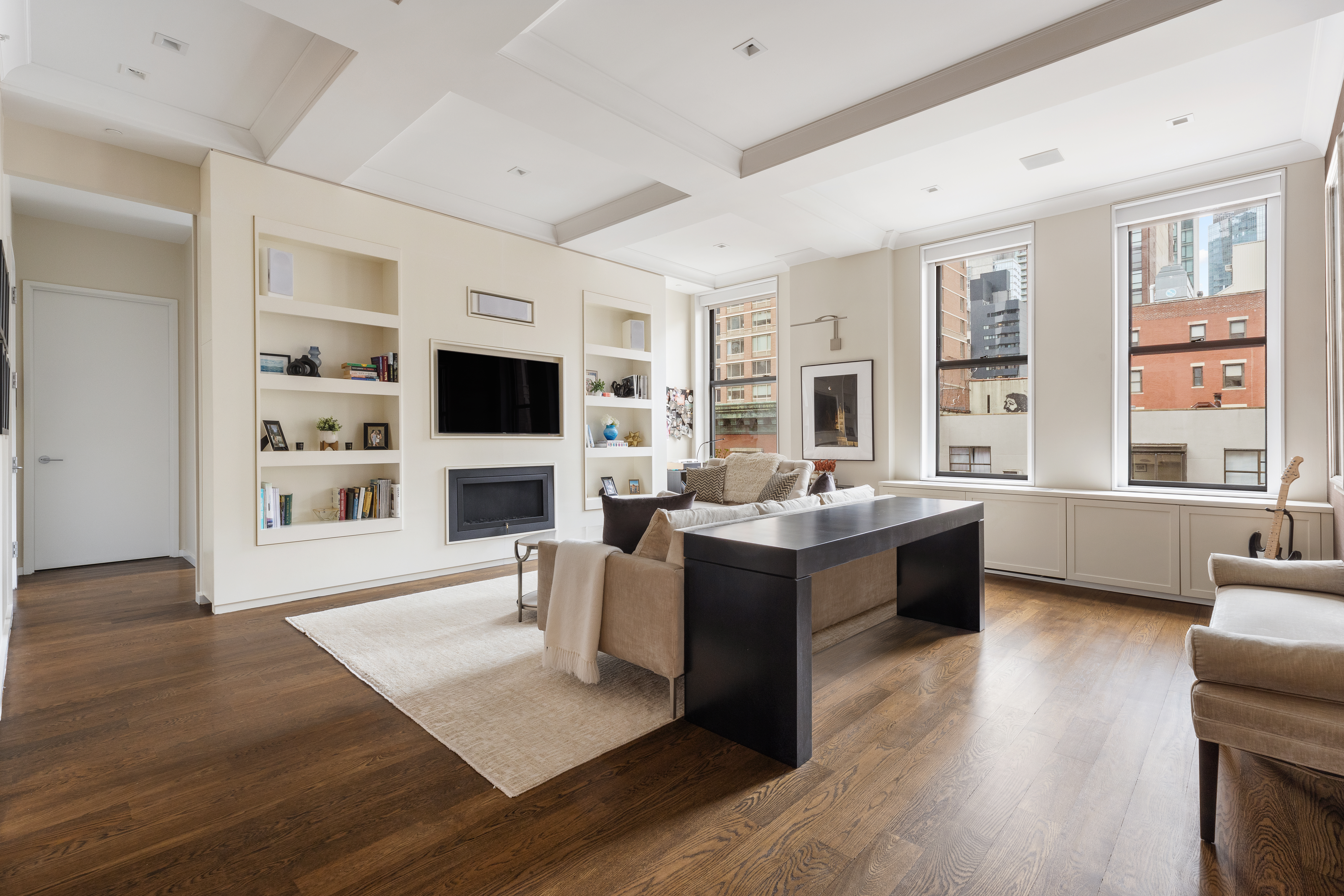 a living room with fireplace furniture and a flat screen tv