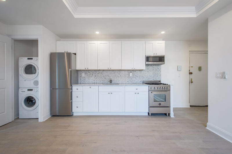 a kitchen with stainless steel appliances granite countertop a refrigerator and a stove