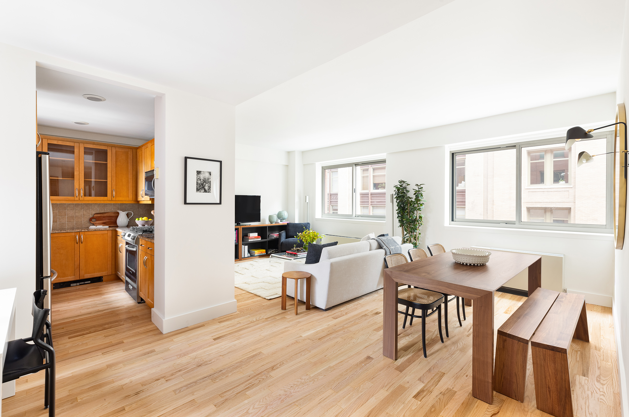 a living room with furniture and a wooden floor