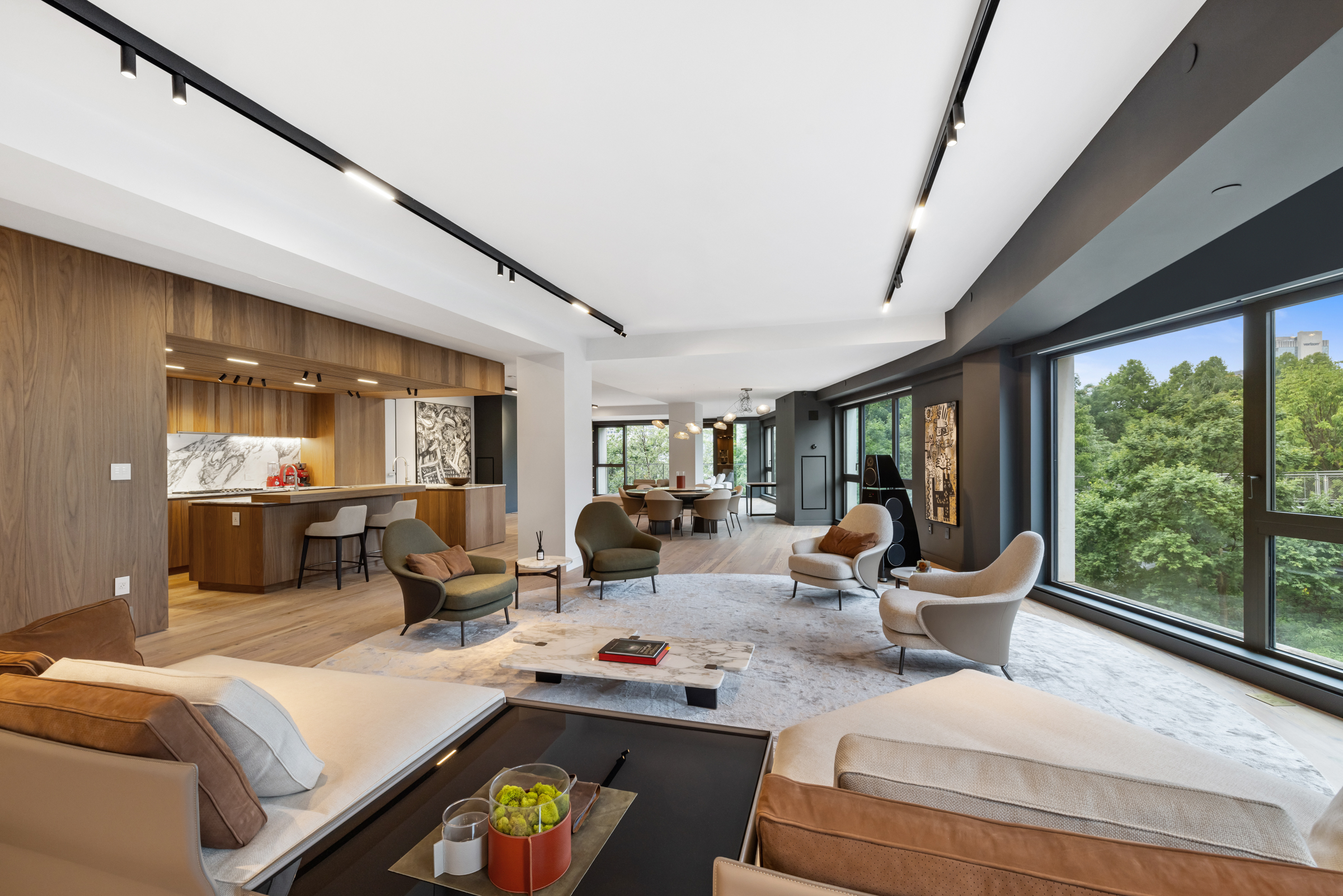 a living room with furniture large window and chairs