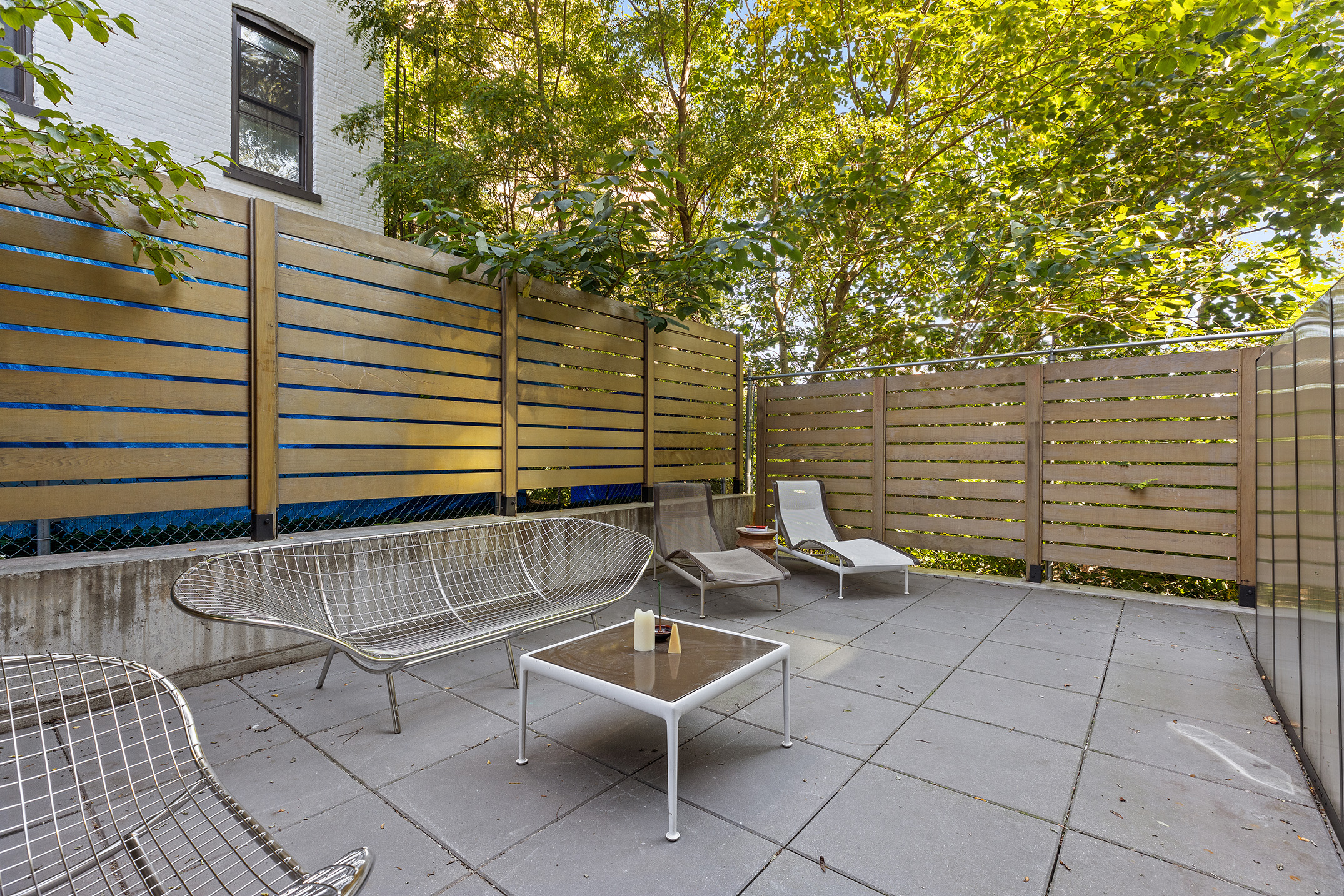 a view of a patio with a table and chairs