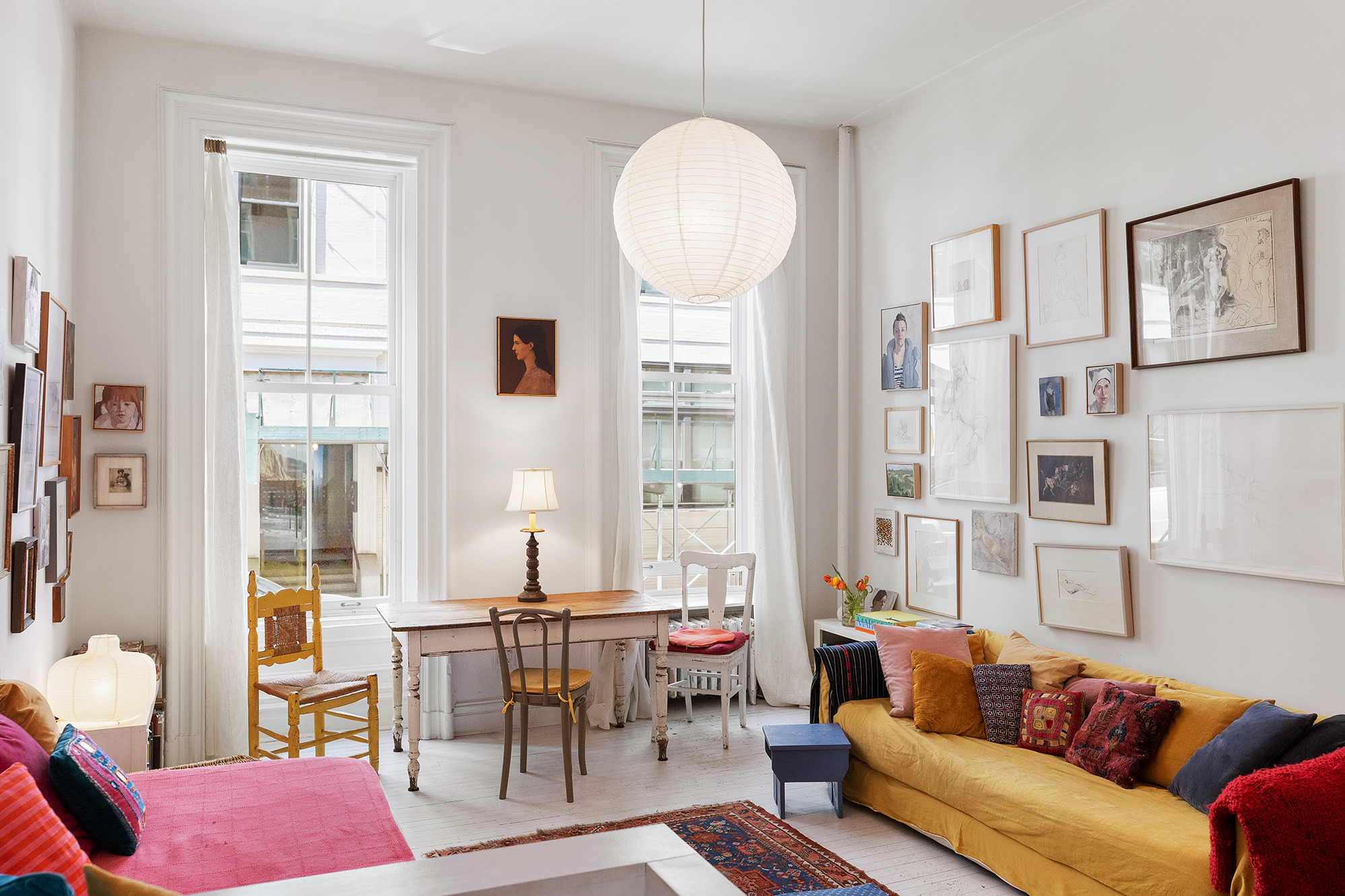 a living room with furniture a table and a large window