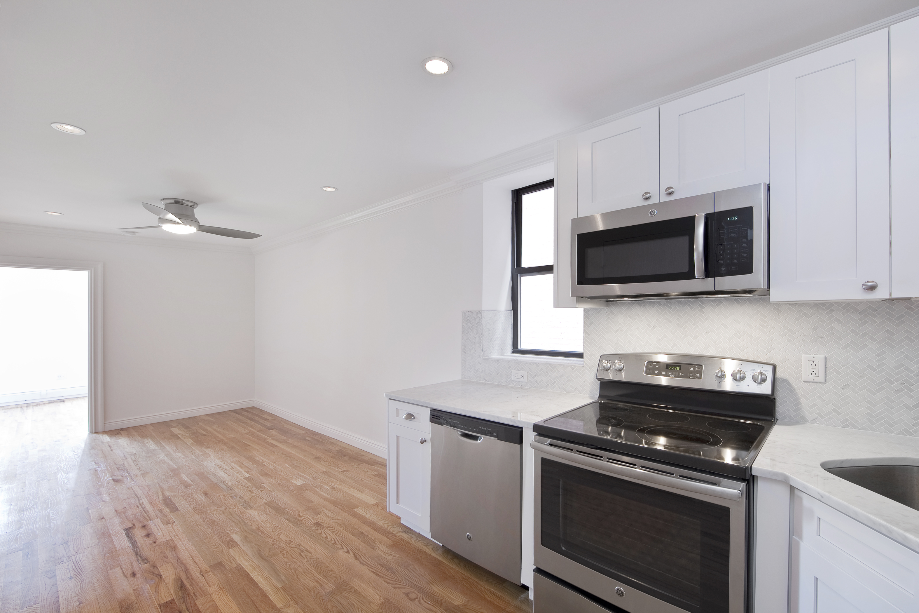 a kitchen with stainless steel appliances a stove a microwave and cabinets