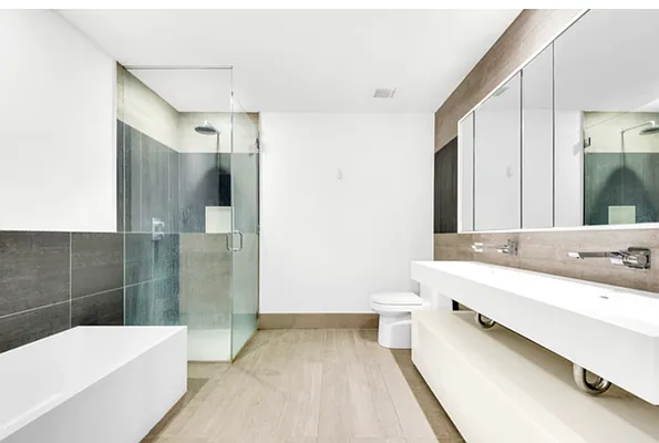 a bathroom with a double vanity sink toilet and shower