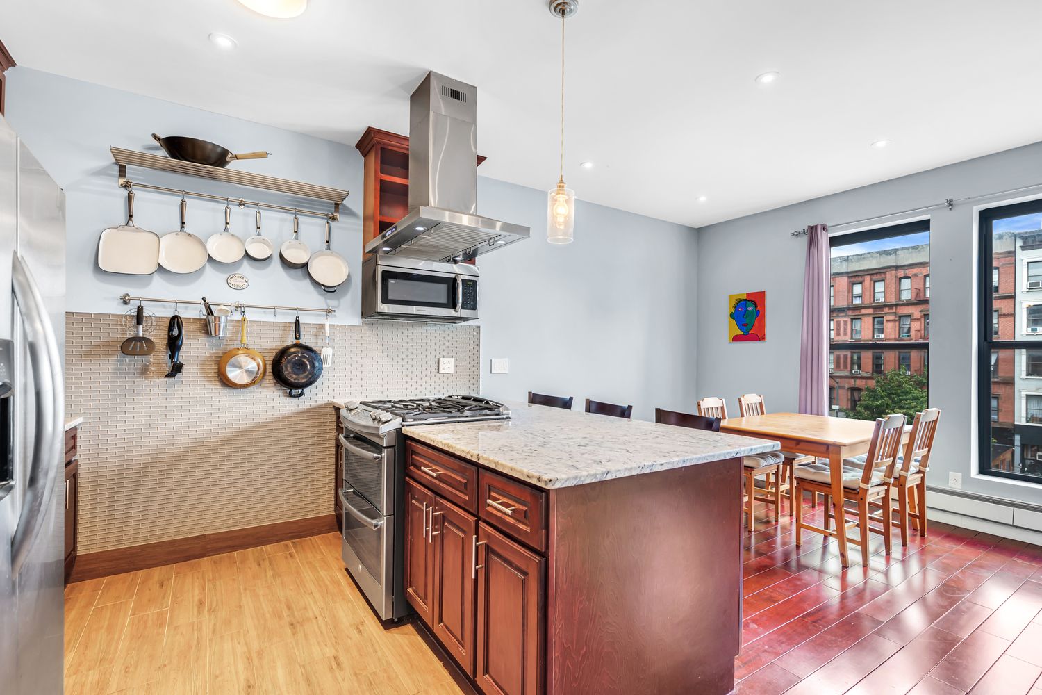 a kitchen with a sink a stove and chairs