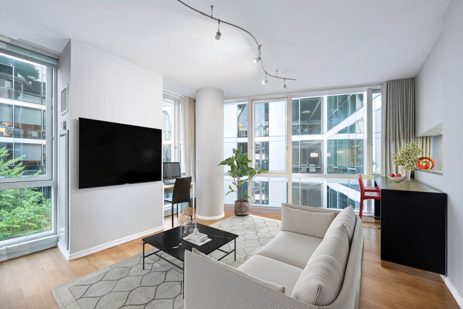 a living room with furniture and a flat screen tv