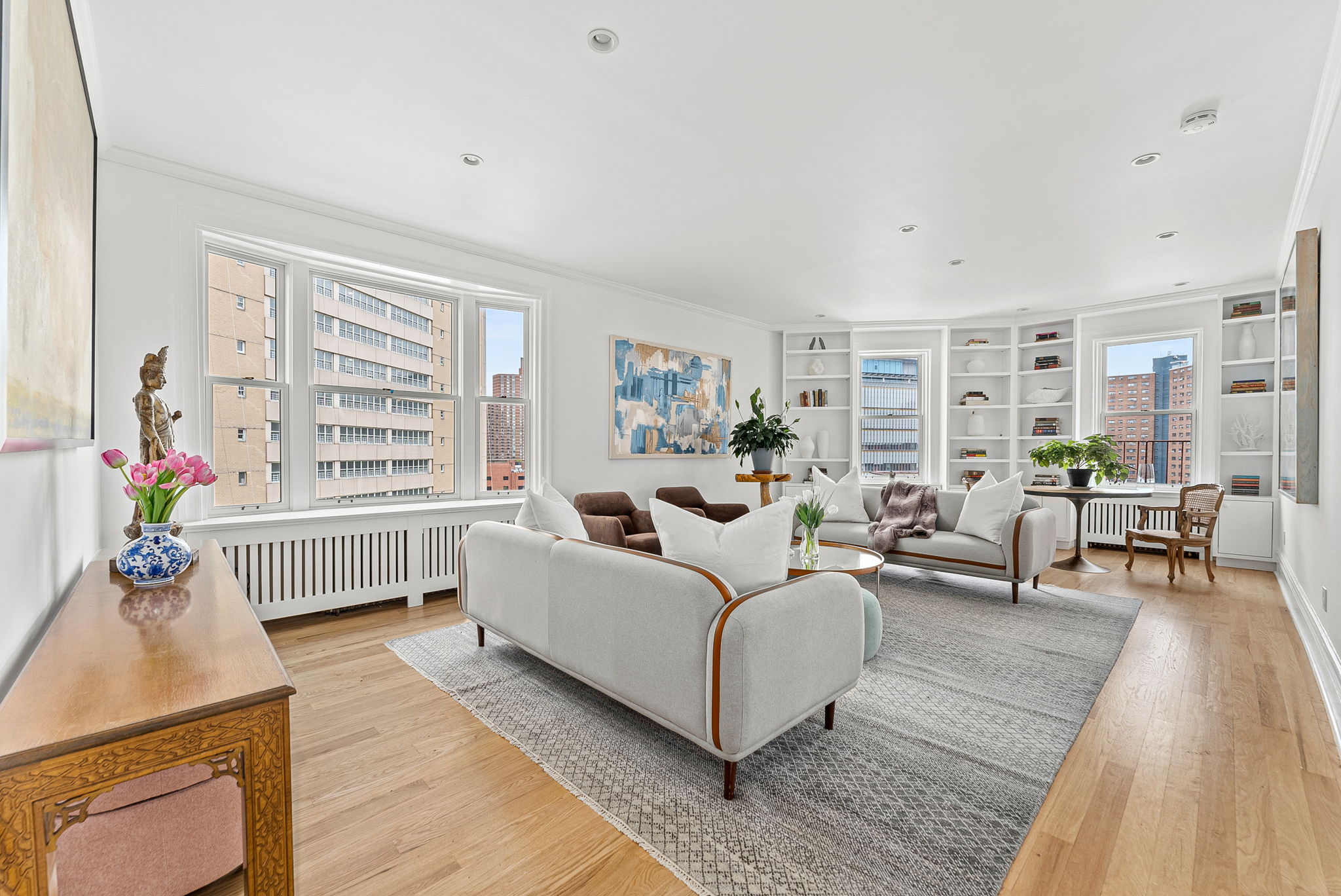 a living room with furniture and wooden floor