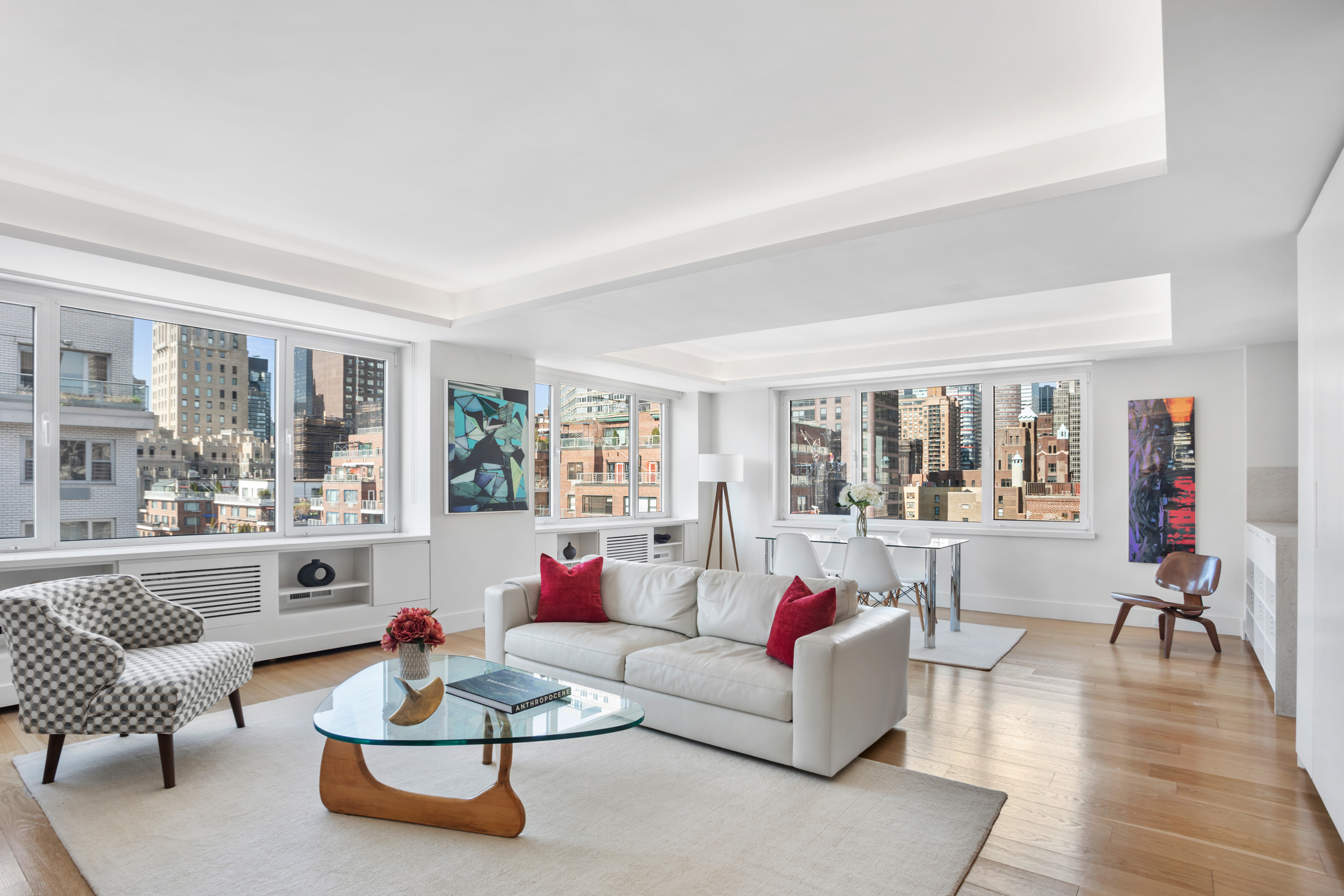 a living room with furniture and floor to ceiling windows